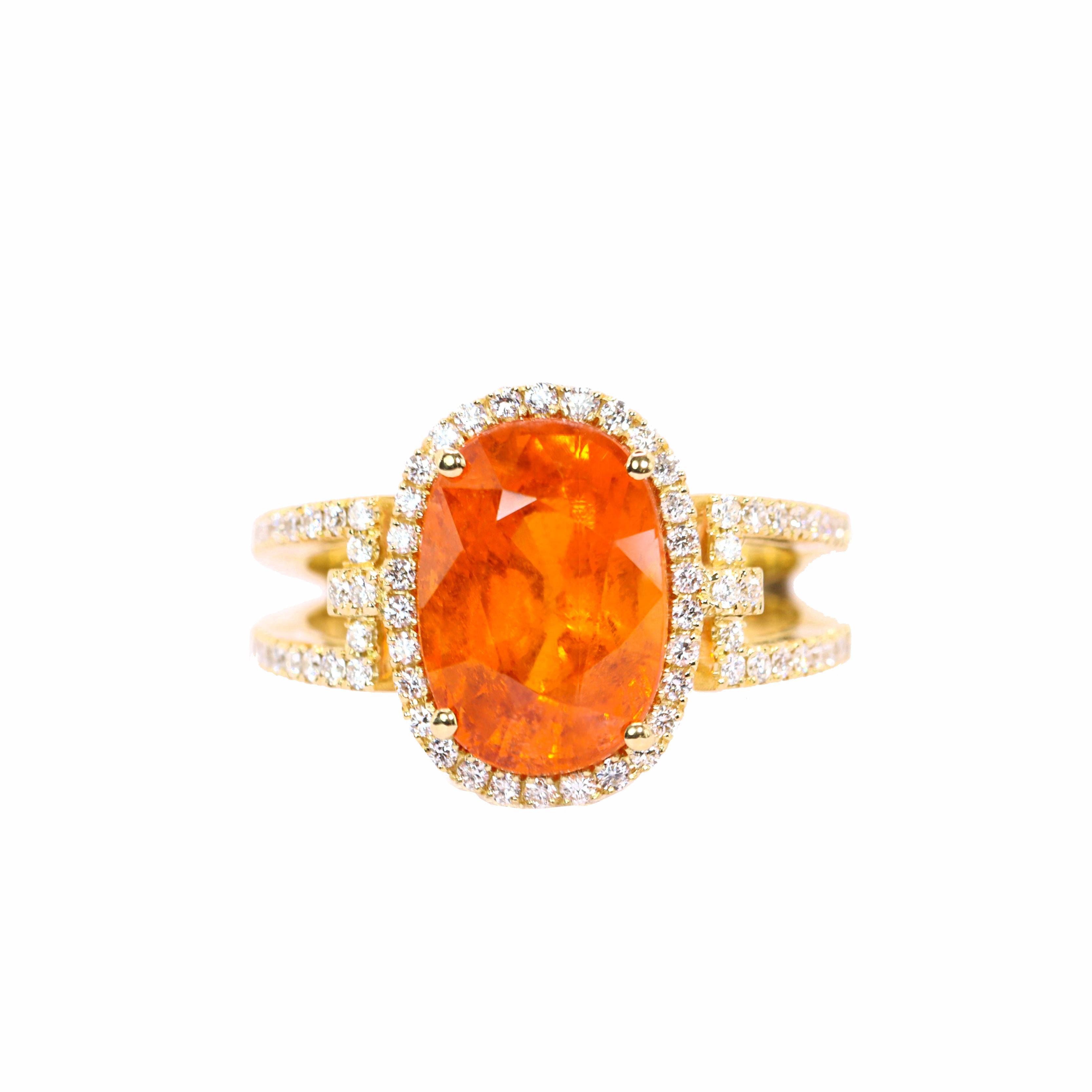 S.Georgios designer presents an exquisite 18K Yellow Gold Ring featuring an oval-cut 7,02 Carats Mandarin Garnet at its center. This vibrant gemstone is elegantly surrounded by brilliant cut diamonds, total weight of 0.45 carats.  Handmade in