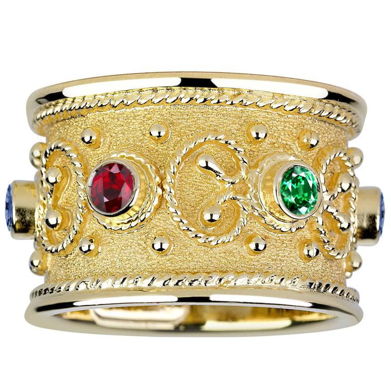 S.Georgios design ring is handcrafted from solid 18 Karat Yellow Gold and is microscopically decorated all the way around with gold beads and wires shaped like the last letter of the Greek Alphabet - Omega, which symbolizes eternal life. 
Granulated