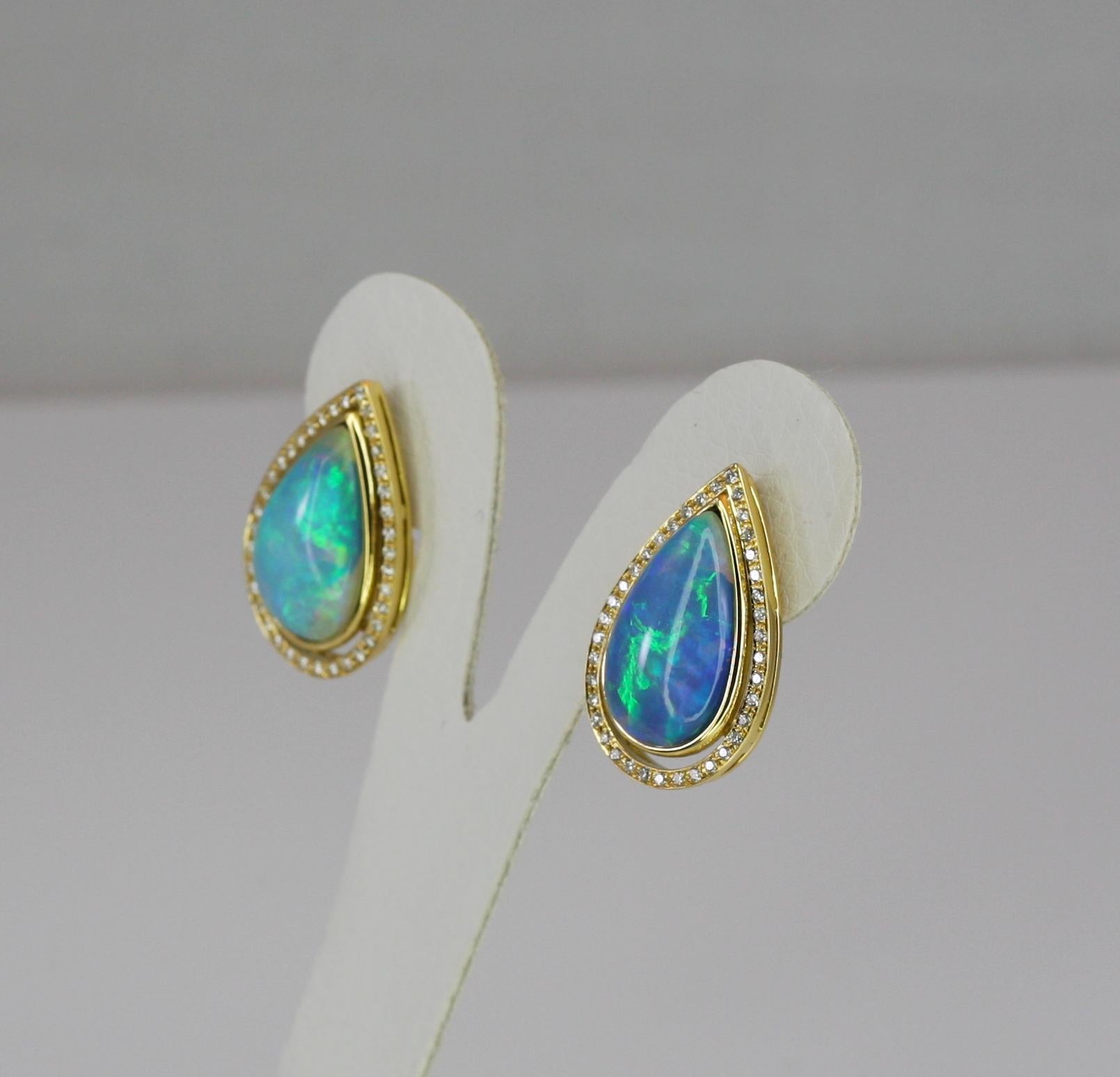 S.Georgios designer earrings are handmade 18 Karat Yellow Gold and feature a pear shape Australian Opals, both total weight of 11.54 Carat. These gorgeous and classic earrings also feature Brilliant cut white diamonds total weight of 0.65 Carat