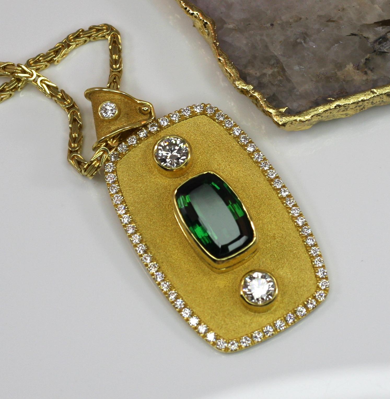 Heavy pendant by S.Georgios designer was handmade from solid 18 Karat Yellow Gold and is microscopically decorated with the Byzantine velvet background. The pendant features exclusive 11.63 Carat Cushion Cut Green Turmaline and 2 Brilliant cut White