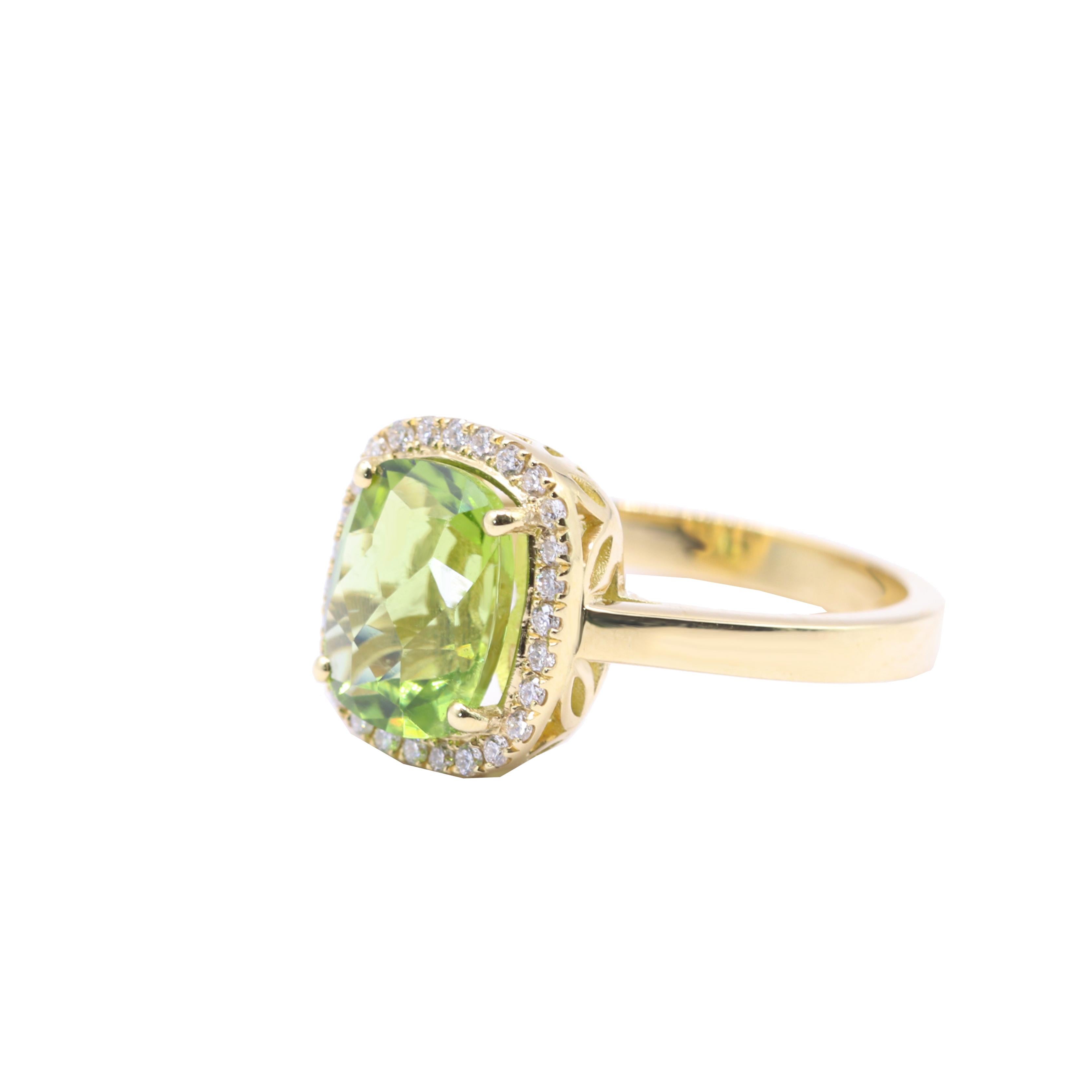 S.Georgios designer presents an oval shape 2.95 Carats Peridot ring with a White Diamond Bezel with a total weight of 0.14 Carats. This simple yet stunning ring is handmade from 18 Karat Yellow gold in Athens Greece. The ring features a beautiful