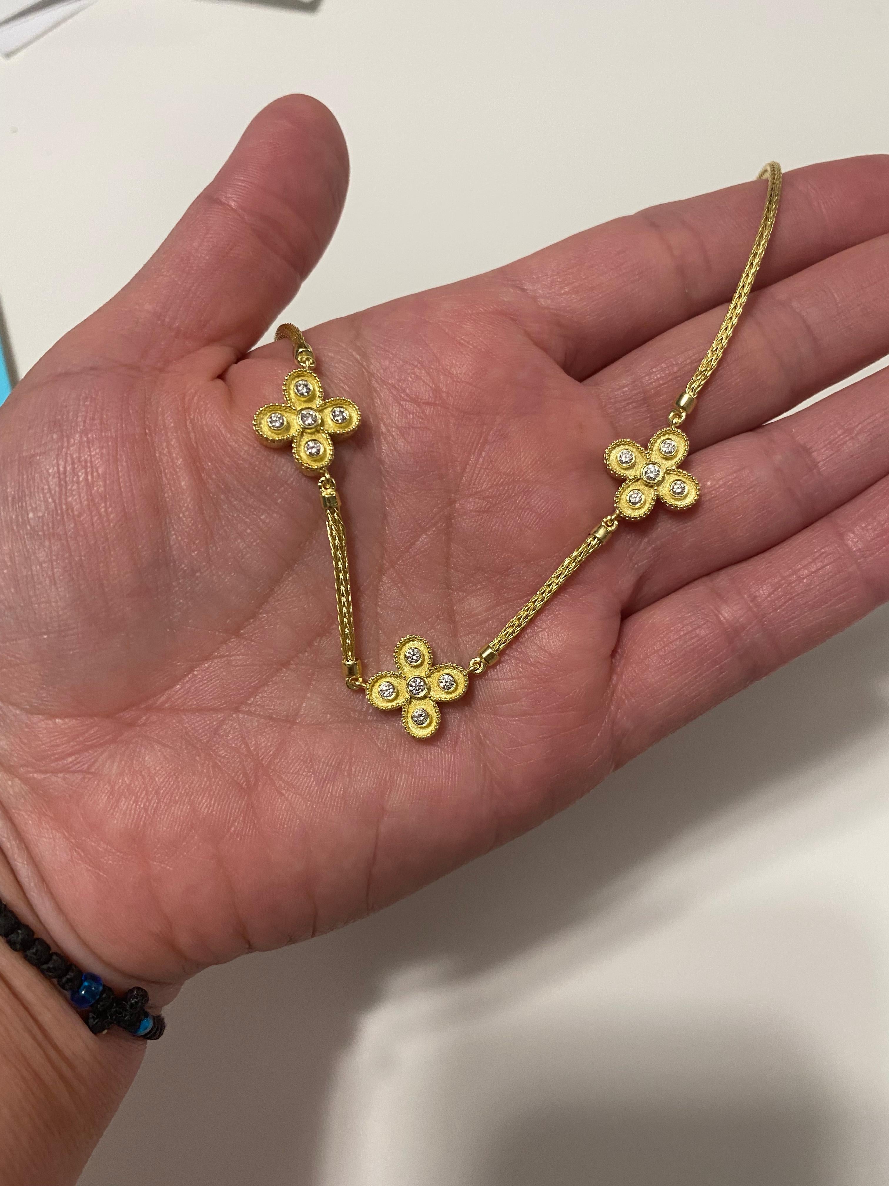 This S.Georgios designer 18 Karat Gold reversible necklace is a combination of three diamond decorated crosses and a rope chain. Crosses are microscopically decorated in Byzantine style with granulation work and 0.48 carat Brilliant cut white