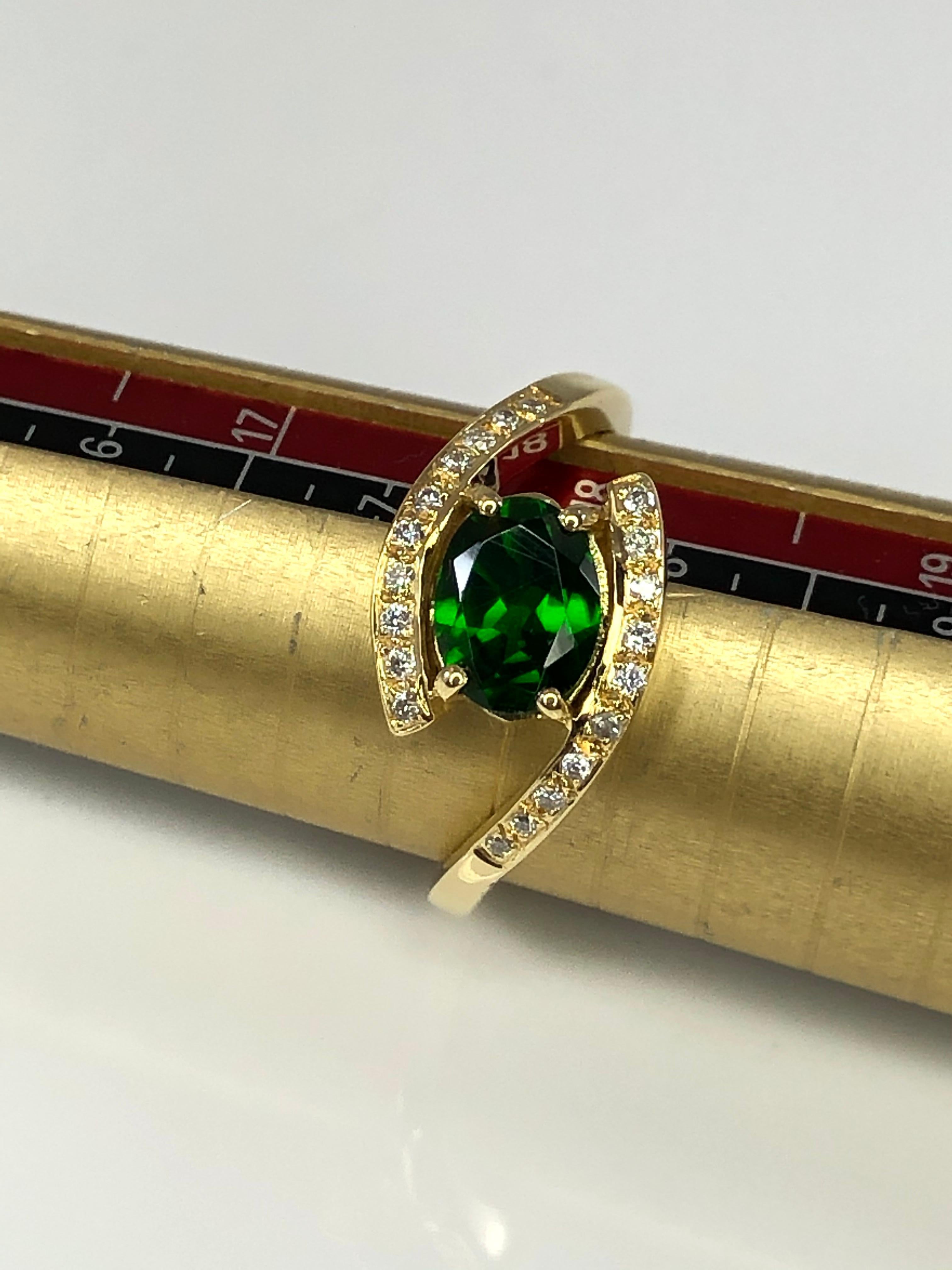 S.Georgios designer band ring is all handmade in our workshop in Greece from 18 Karat Yellow Gold. The beautiful ring features a 1.21 Carat oval cut natural Tsavorite center and 0.12 Carat brilliant cut White Diamond decoration.
This design can also