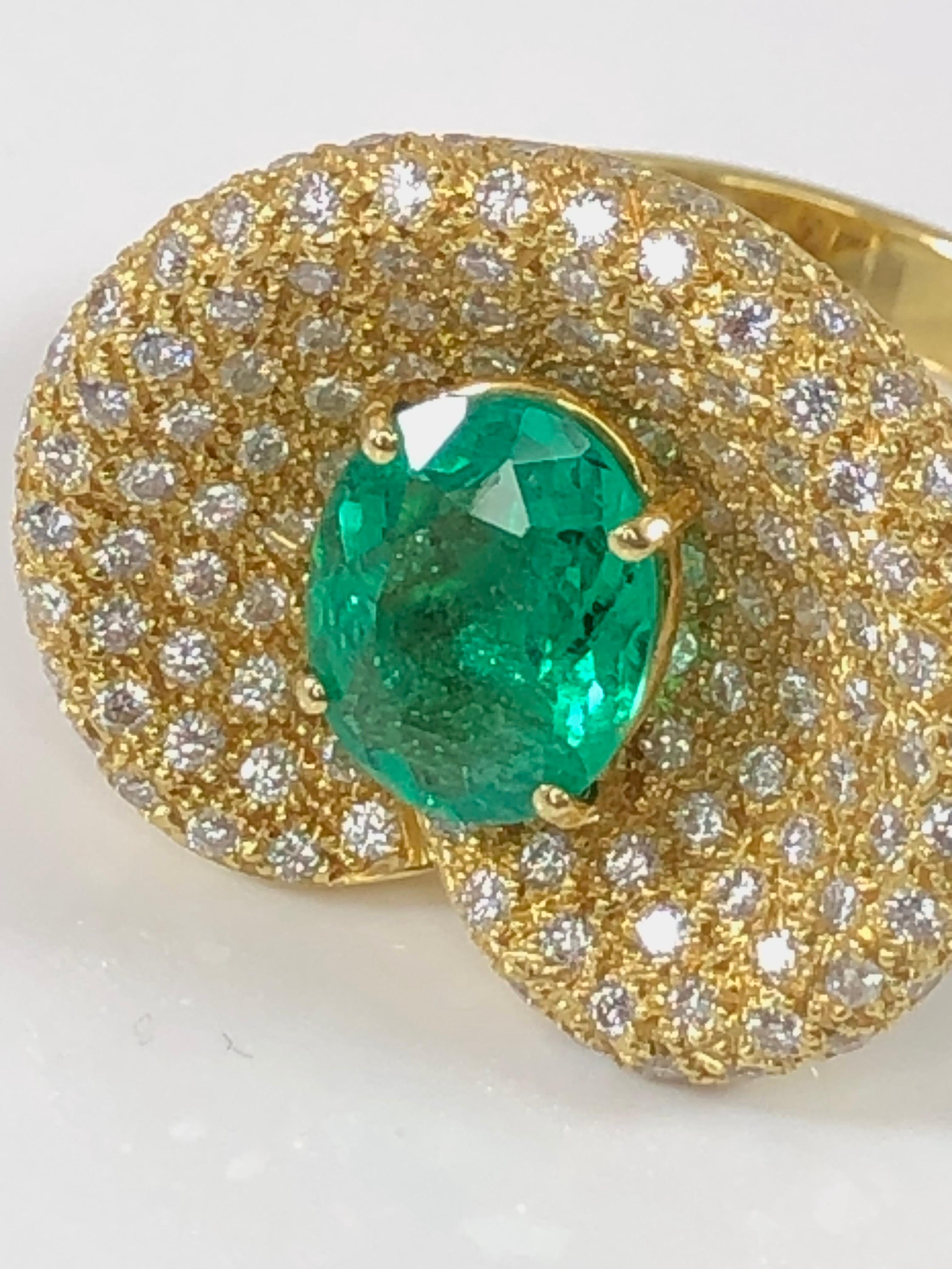 S.Georgios designer ring is all handmade in our workshop in Greece from 18 Karat Yellow Gold. The beautiful ring features a 2.44 Carat oval cut natural Emerald center and 1.68 Carat brilliant cut White Diamond microscopically set all around.
This