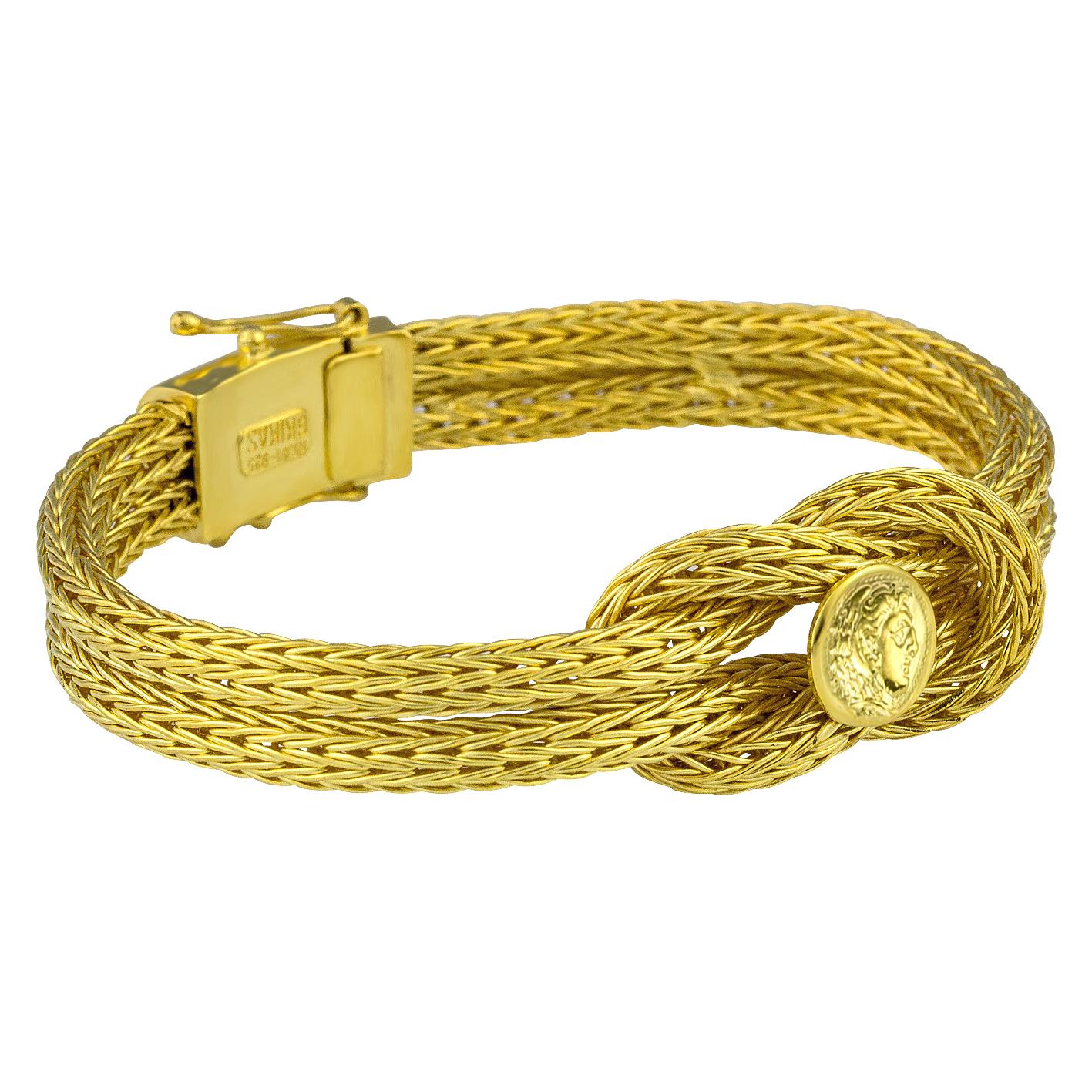S.Georgios designer bracelet handknitted in our workshop in Greece from 18 Karat yellow gold threads all custom-made. This flexible bracelet decorates Hercules Knot, the symbol of strength, healing, and protection, and a replica of the Alexander The