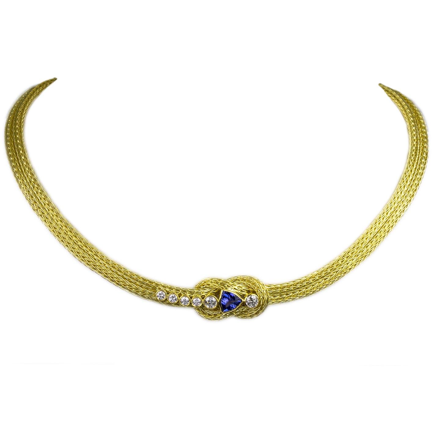 Luxurious and striking S.Georgios design rope necklace with Hercules Knot, Diamonds, and Tanzanite all custom made. The necklace is handknitted from in 18 Karat Yellow Gold in our workshop in Greece and decorated with 6 Brilliant cut White Diamonds,
