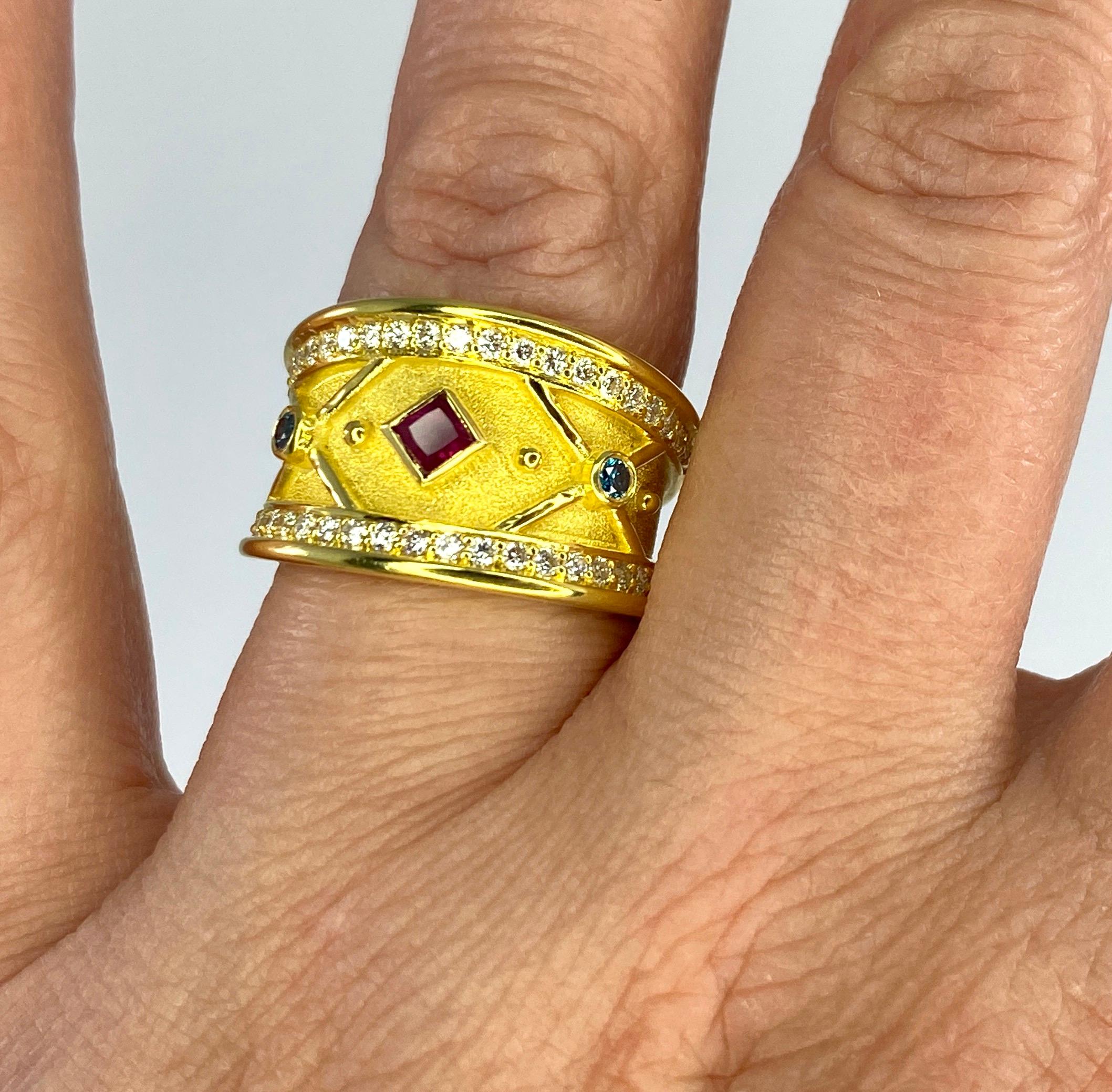 This elegant S.Georgios designer graduated ring is handmade from solid 18 Karat Yellow Gold. The ring is microscopically decorated with 18 Karat yellow gold beds and wires laid against the Byzantine velvet background. The ring features 0.26 Carat