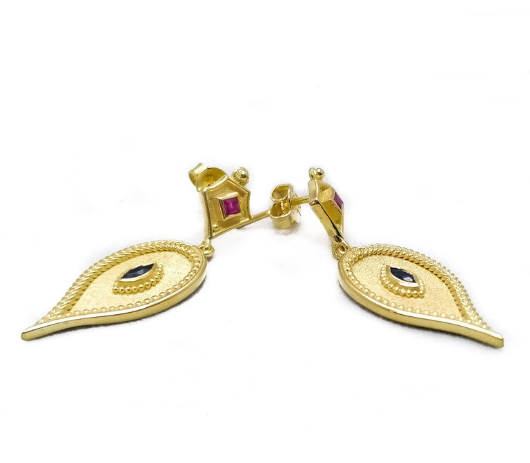 These S.Georgios designer Etruscan-style earrings are all hand made from 18 Karat Yellow Gold and decorated with granulation workmanship done microscopically. This gorgeous pair features 2 princess-cut natural Rubies total weight of 0.18 Carat and 2
