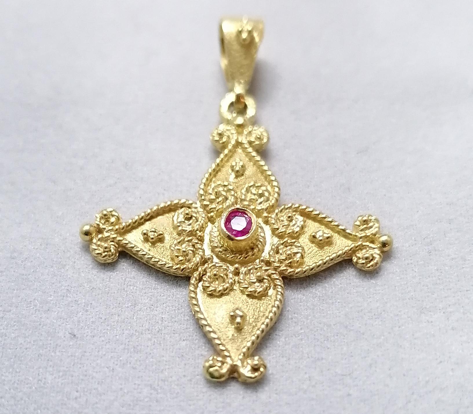 This S.Georgios solid 18 Karat Gold geometric Cross Necklace is handmade with microscopically decorated Byzantine-style granulation work and finished with a unique velvet background. This stunning cross pendant features a delicate brilliant-cut