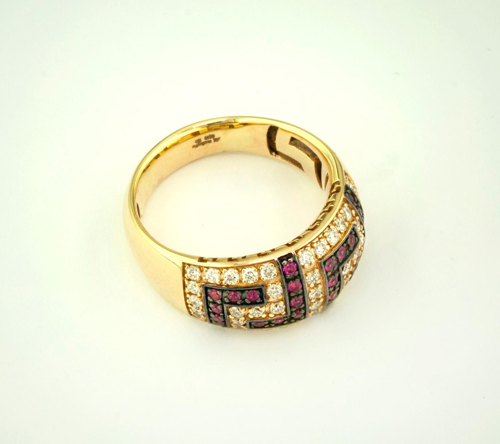 This S.Georgios designer 18 Karat Yellow Gold Greek Key Band Ring is all handmade in a unique two-tone look. The gorgeous band features brilliant cut diamonds forming the Greek Key design total weight of 0.52 Carat, and natural Rubys total weight of