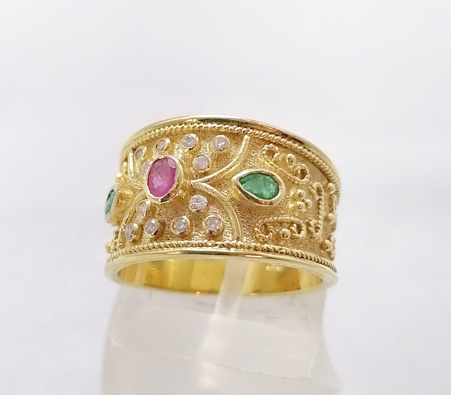This S.Georgios designer 18 Karat Yellow Gold Multicolor wide band Ring is all handmade with Byzantine-style bead granulation and a unique velvet background. This gorgeous band ring features a center oval cut natural Ruby total weight 0.18 Carat,