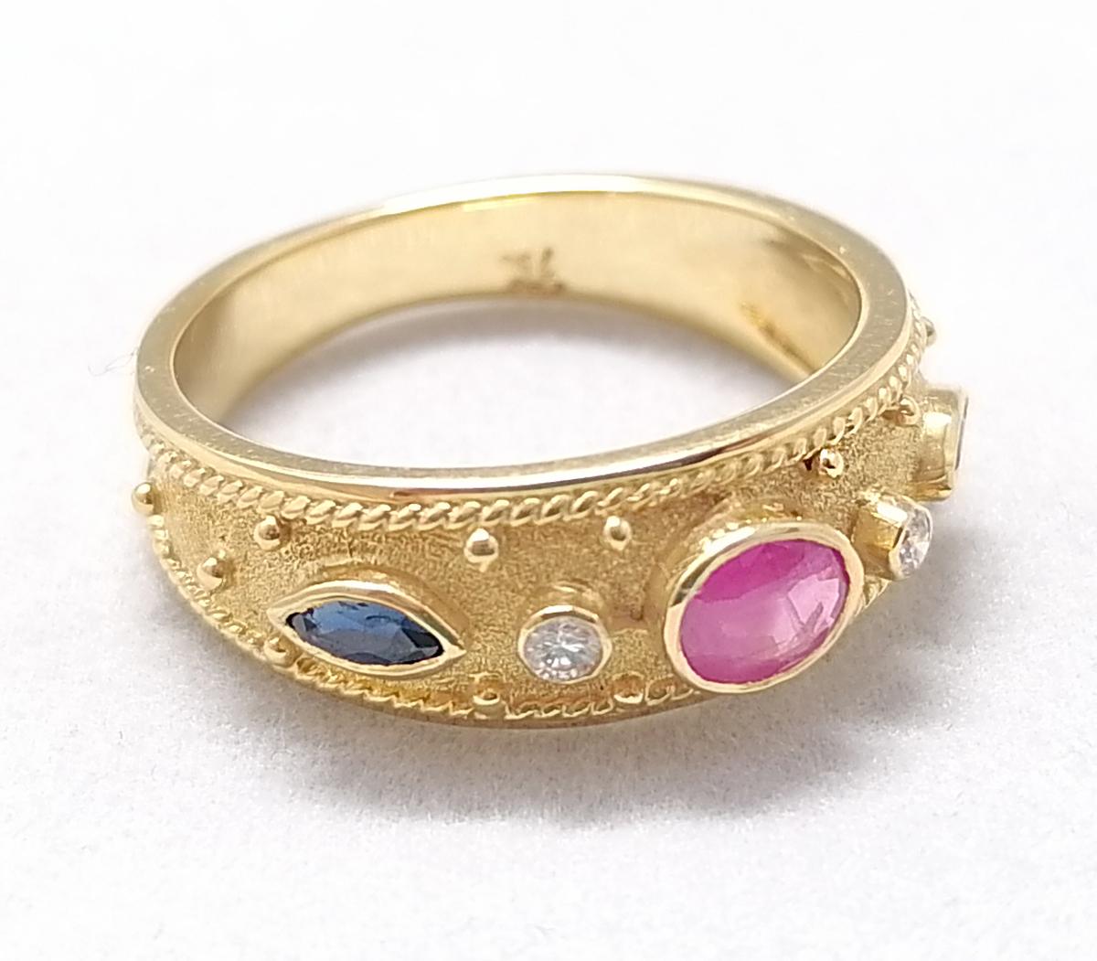 This S.Georgios designer 18 Karat Yellow Gold Multicolor thin band Ring is all handmade with Byzantine-style bead granulation and a unique velvet background. This gorgeous band ring features a center oval natural Ruby total weight 0.44 Carat, framed