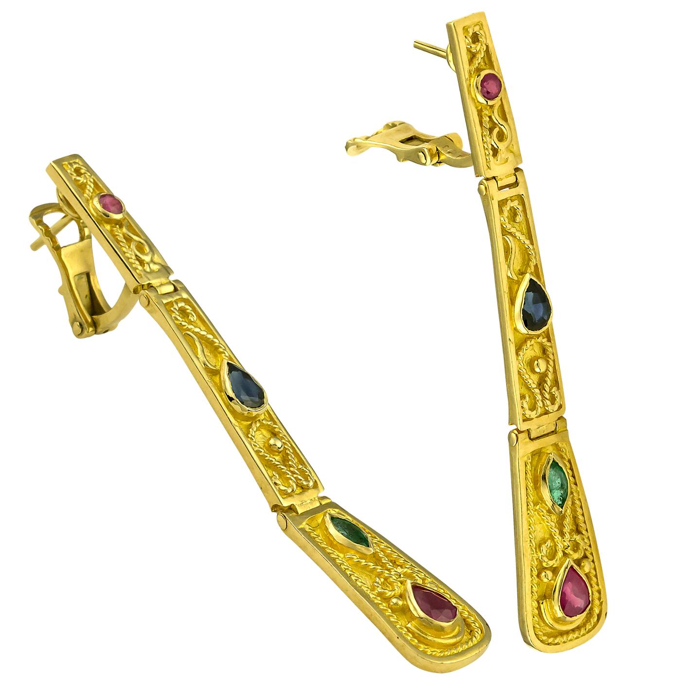 S.Georgios designer Earrings 18 Karat yellow gold all handmade and microscopically decorated with granulation workmanship and a unique velvet finish on the background. This stunning pair of Earrings feature Rubies, Sapphires and Emeralds total