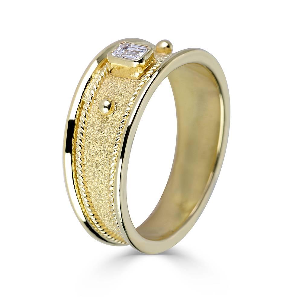 This S.Georgios designer ring in solid 18 Karat Yellow Gold all handmade with Byzantine workmanship and a unique velvet look on the background. This Unisex gorgeous ring features an emerald-cut White Diamond VVS1 -F color with a weight of 0.20