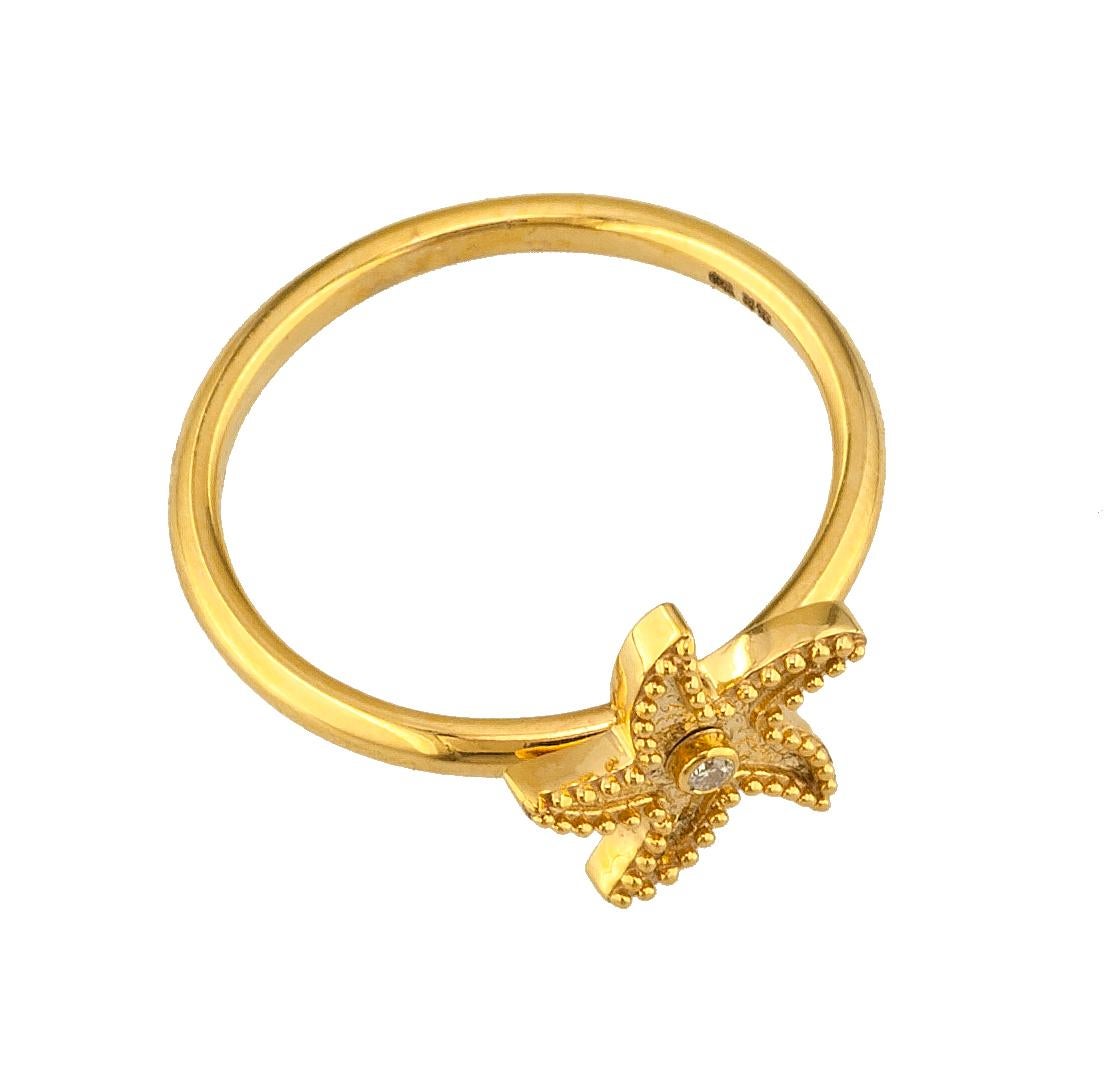 This S.Georgios designer thin band ring is 18 Karat yellow gold and microscopically decorated with hand-made  granulation workmanship, and finished with a unique contrast velvet look. This beautiful starfish ring features a brilliant-cut White