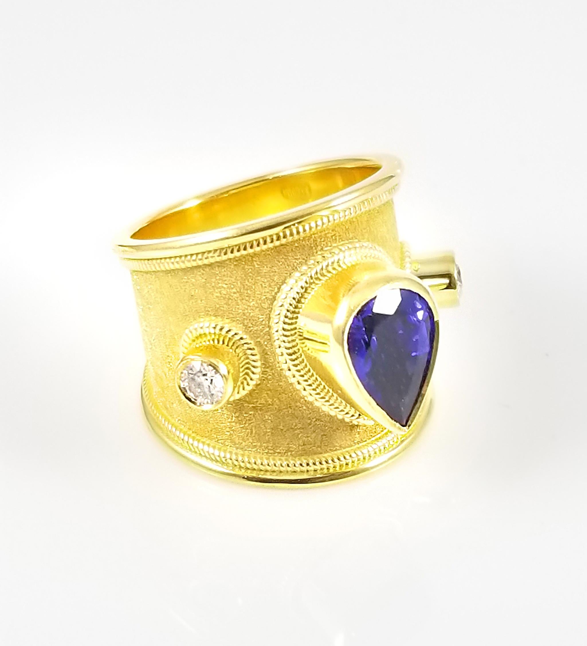 S.Georgios designer 18 Karat Solid Yellow Gold Wide Band Ring all handmade with the Byzantine granulation workmanship and a stunning unique velvet background. The gorgeous Ring has a center Pear Shape natural Tanzanite total weight of 3,48 Carats