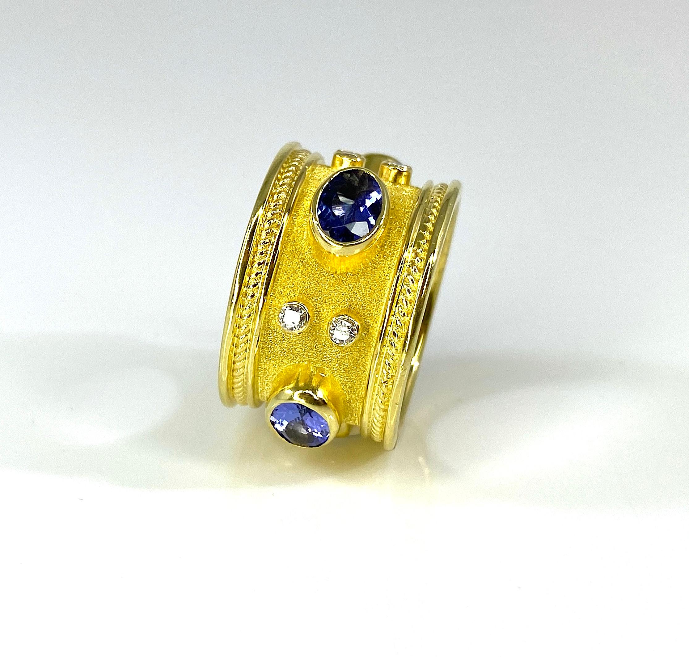 The is gorgeous S.Georgios designer 18 Karat Solid Yellow Gold Wide Band Ring all handmade in Greece in the Byzantine style with very bold elegant look. Ring features 4 oval cut Tanzanites in total weight of 2.78 Carats and 8 brilliant cut white