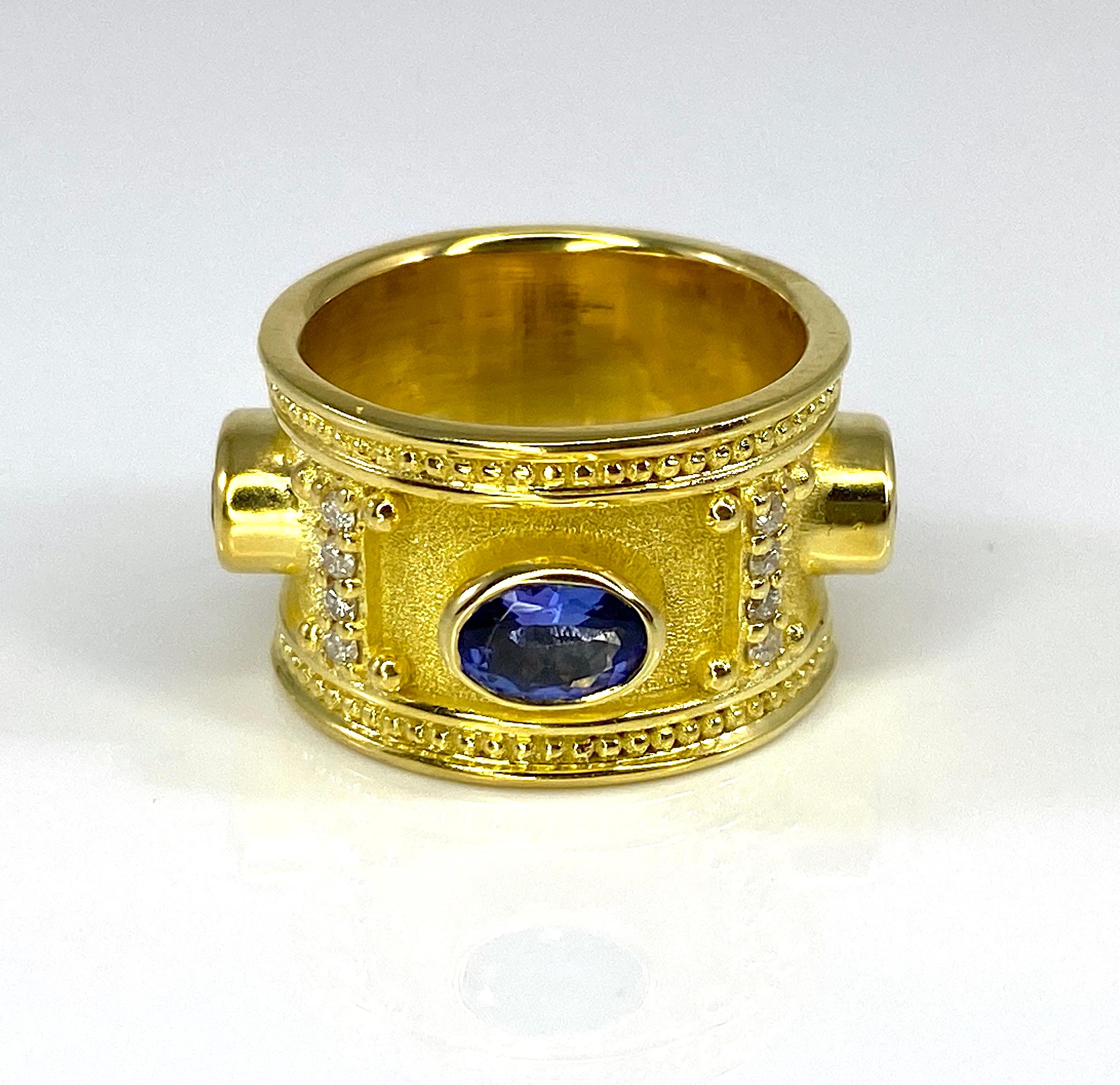The is gorgeous S.Georgios designer 18 Karat Solid Yellow Gold Wide Band Ring all handmade in Greece in the elegant look inspired by Byzantine era. Ring is heavily decorated with granulation details and features 4 oval cut Tanzanites in total weight
