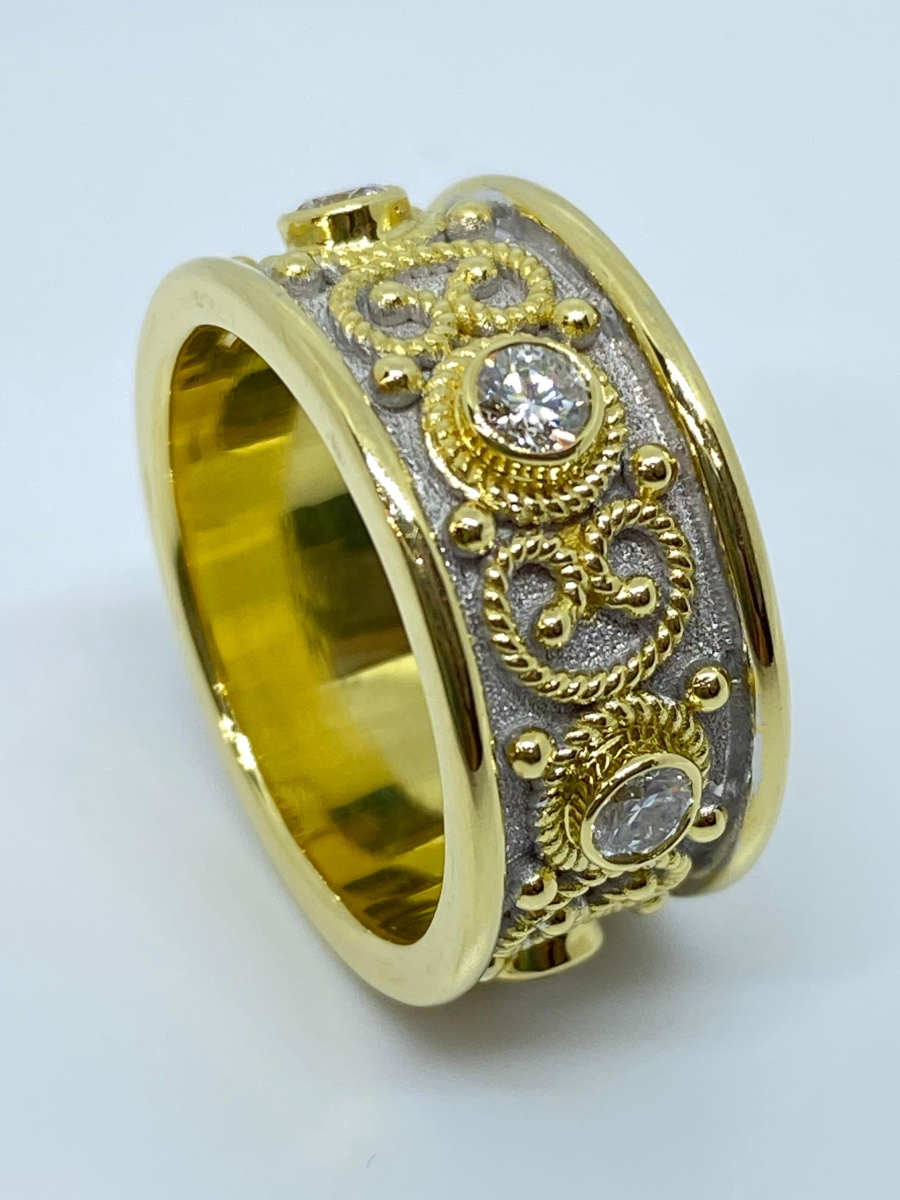 S.Georgios designer Diamond Band Ring is handmade from solid 18 Karat Yellow Gold. The beautiful Yellow Gold Band ring is microscopically decorated all the way around with Yellow Gold bead granulation and finished with unique Byzantine White Rhodium