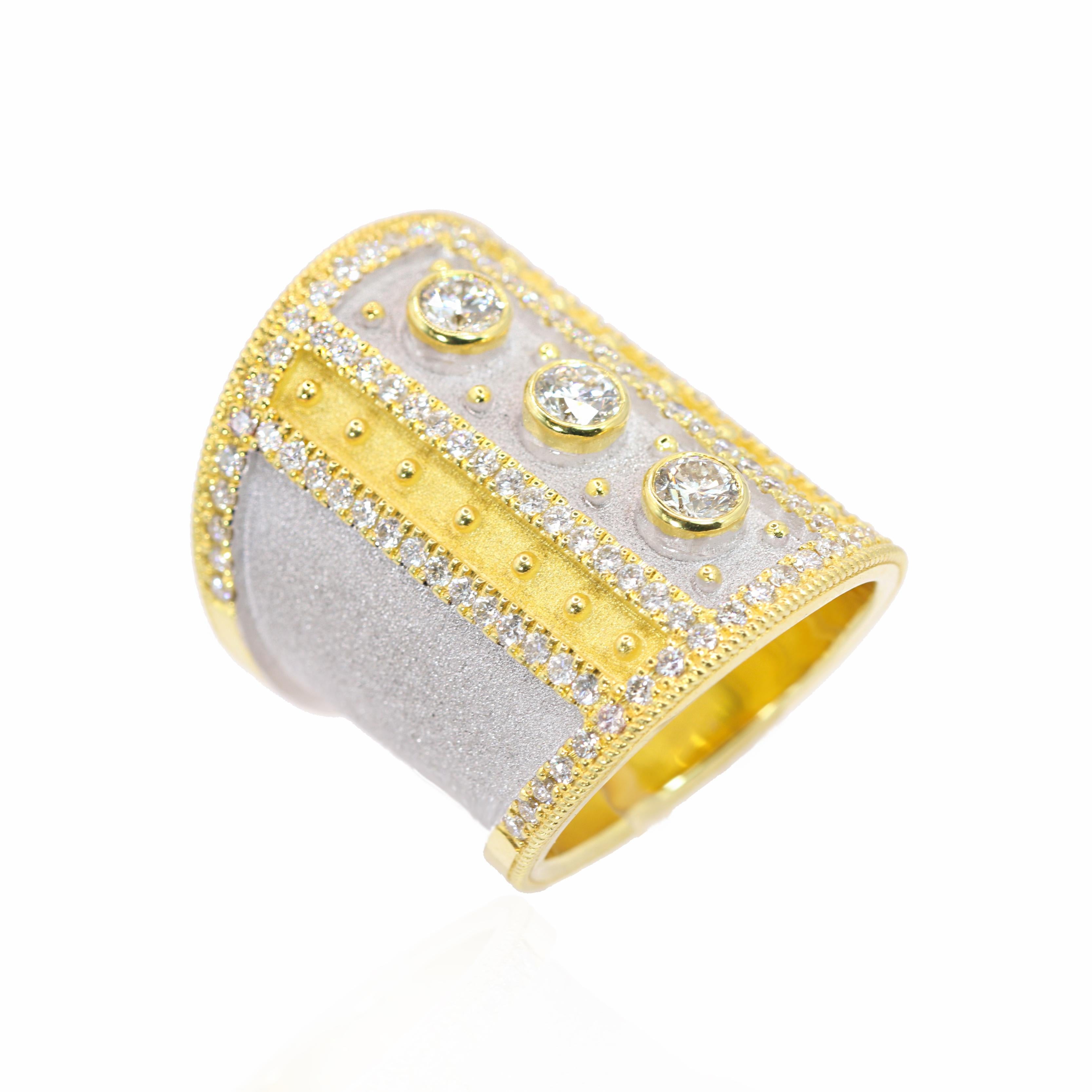 S.Georgios Designer presents an exquisite handmade Wide Diamond Ring from 21.20 grams of solid 18 Karat yellow gold in Byzantine style with a unique velvet texture on the background and White Rhodium finish.
The gorgeous art piece features 3 big