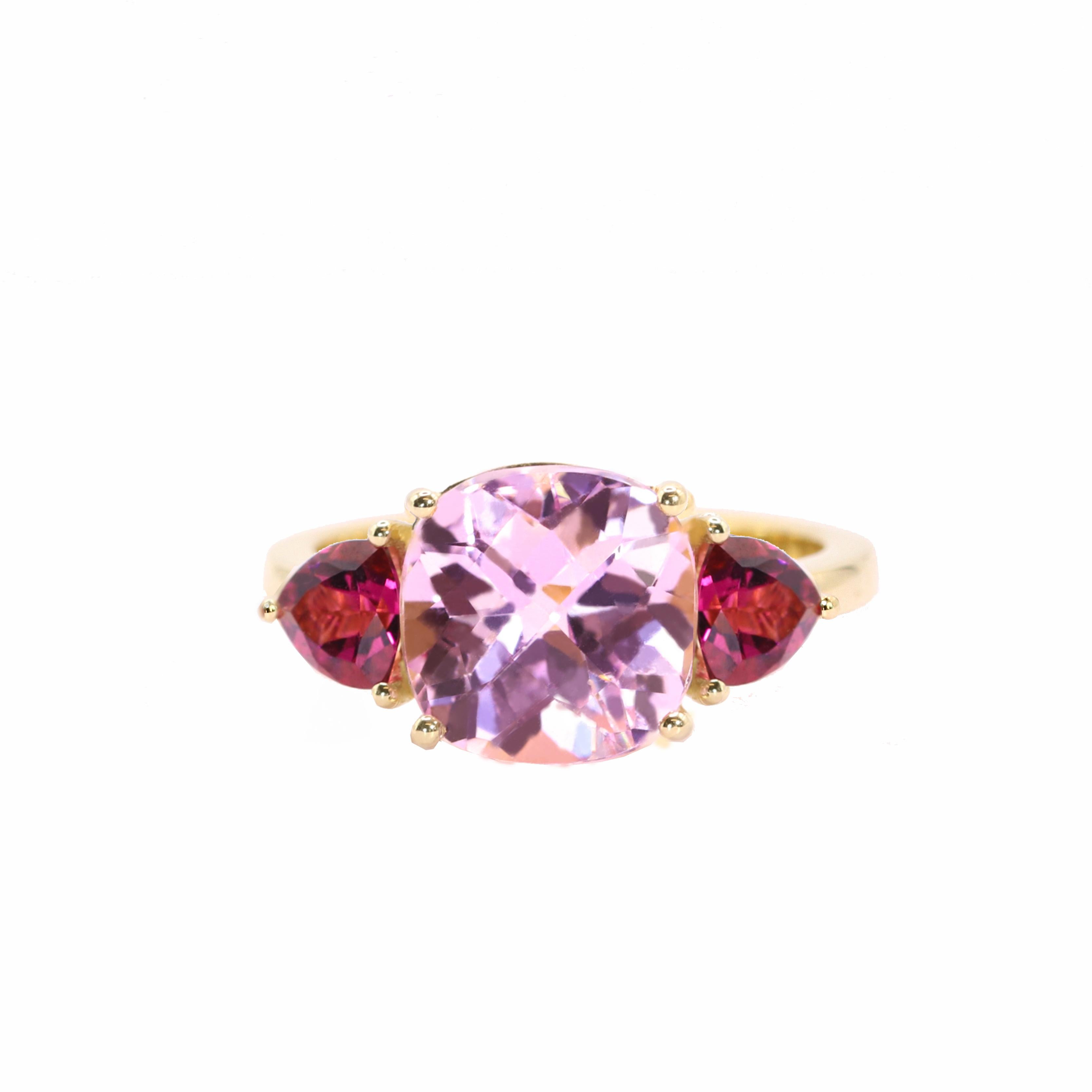 S.Georgios designer presents a cushion shape 4.87 Carats Kunzite Ring with two triangle Tourmalines with a total weight of 0.92 Carats. This simple yet stunning ring is handmade from 18 Karat Yellow gold in Athens Greece. The ring features a