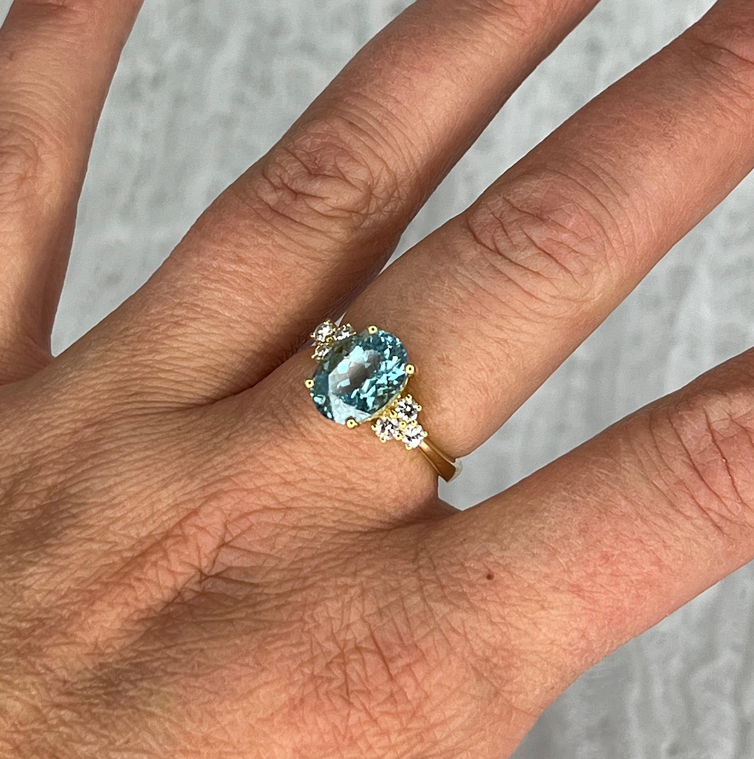 This S.Georgios designer Yellow Gold 18 Karat Ring features a gorgeous Oval shape Aquamarine with a weight of 3.01 Carats and six (6) Brilliant-cut White Diamonds with a total weight of 0.32 Carat on the sides. This stunning classic and super
