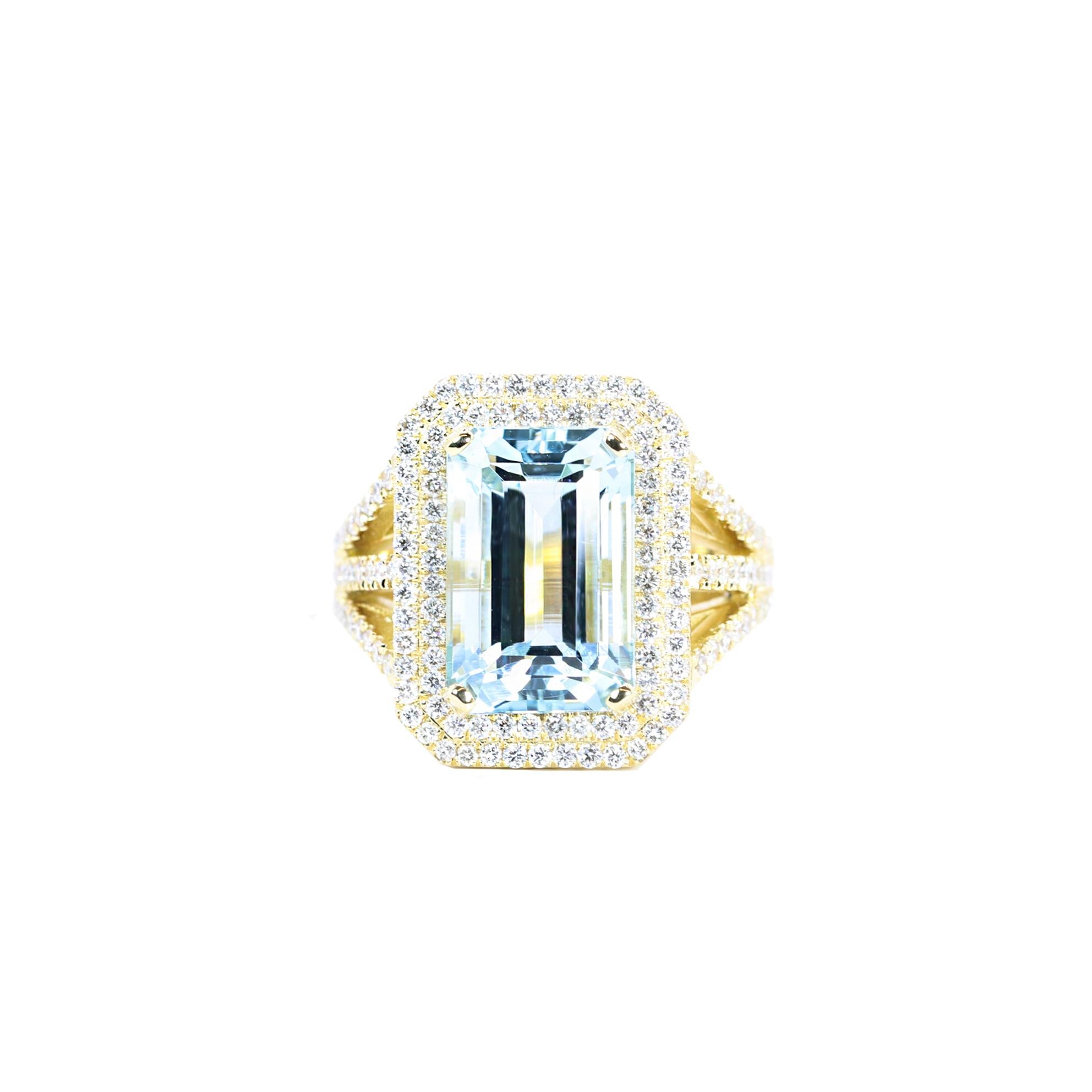 S.Georgios designer presents an exquisite 18K Yellow Gold Ring featuring a large emerald-cut Aquamarine totlal weight of 8.70 Carats surrounded by brilliant-cut Diamonds. The band is adorned with three lines of additional brilliant-cut Diamonds,