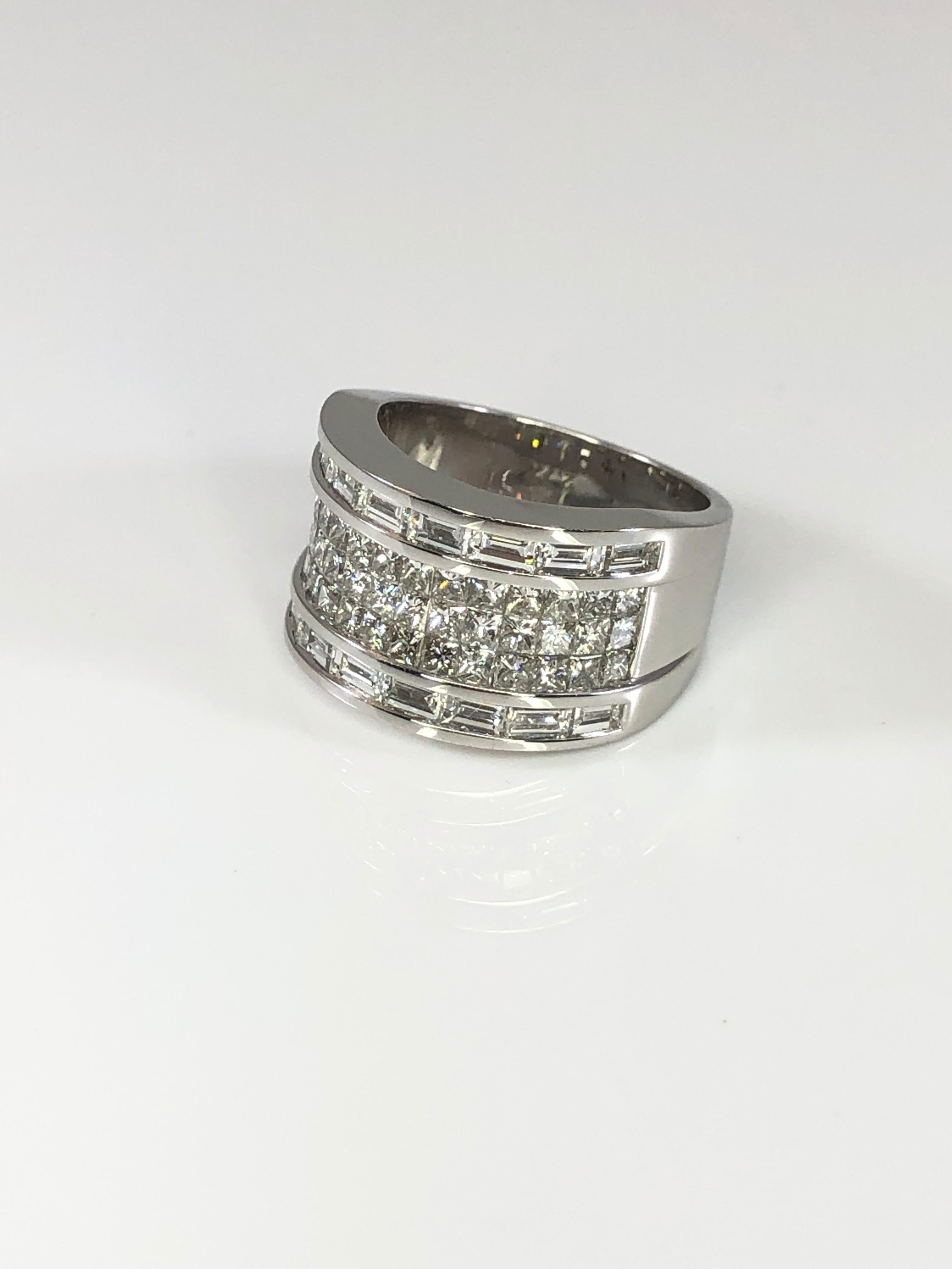 S.Georgios designer wide band made with invisible princess cut diamonds in the middle and baguette-cut lows on the outer sides. This gorgeous ring is handmade from 18 Karat White gold in Athens Greece and featuring a total weight of 2.90 Carat of