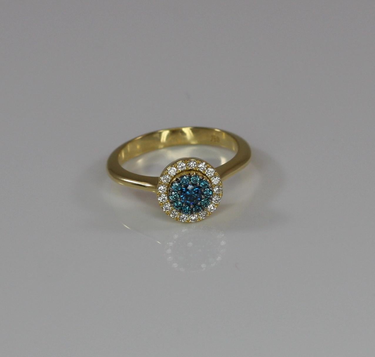 S. Georgios designer ring in solid 18 Karat Yellow gold and all hand made. It features Brilliant cut Blue Diamonds with a total weight of 0.24 Carats and White Diamonds with a brilliant-cut total weight of 0.20 Carats. This elegant piece is all