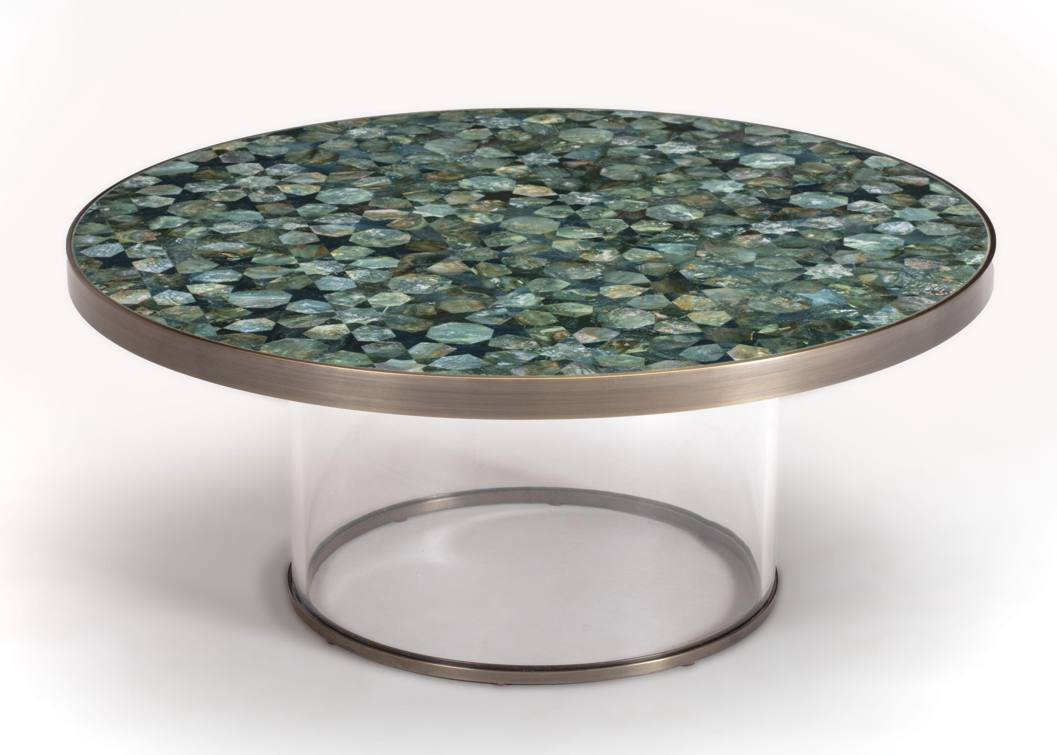 Inspired by the Moghul courts of India, this cocktail table is fabricated with a semi-precious inlaid stone top and plexiglass and bronze base. Made in India.

Finish options:
Green aventurine with green agate.
Lapis Lazuli in two tones.
Available