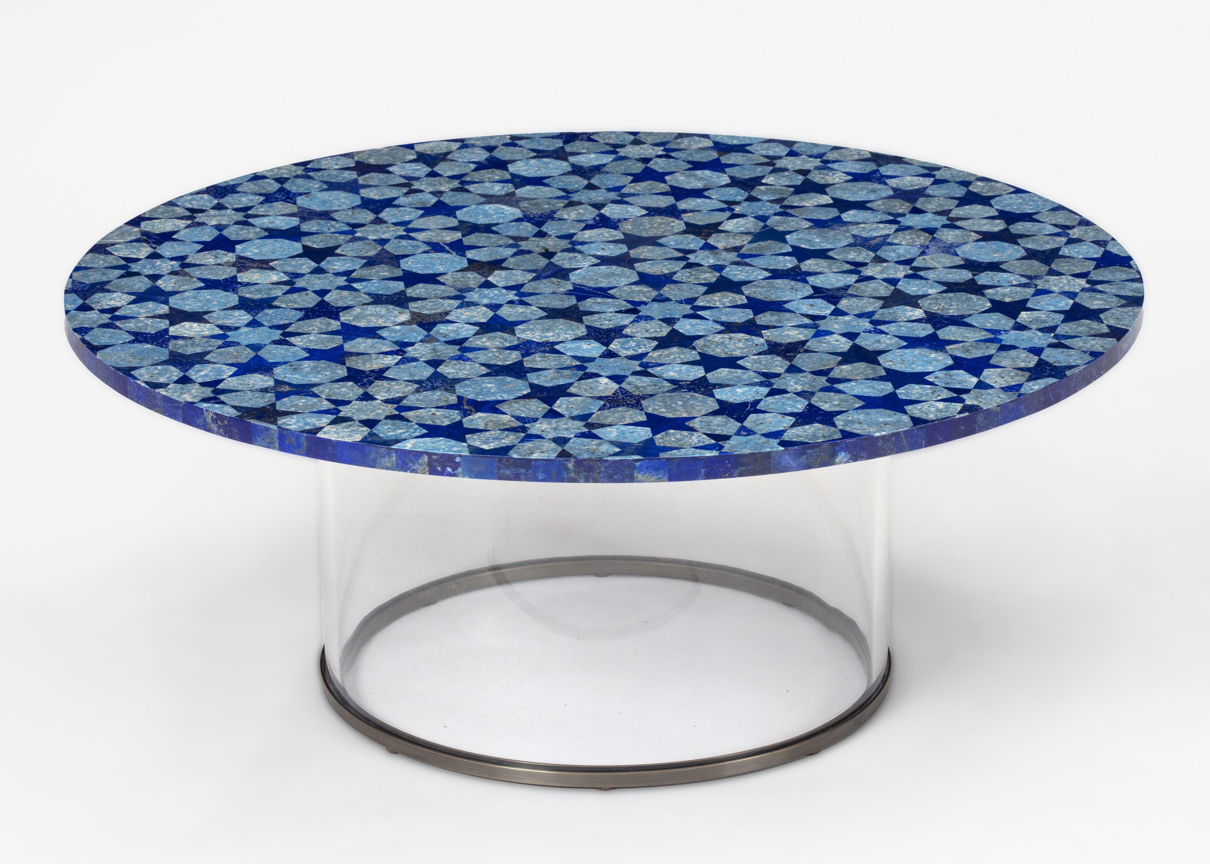 Inspired by the Moghul courts of India, this cocktail table is fabricated with a semi-precious inlaid stone top and plexiglass and bronze base. Made in India.

Finish options:
Green aventurine with green agate.
Lapis Lazuli in two tones.
Available