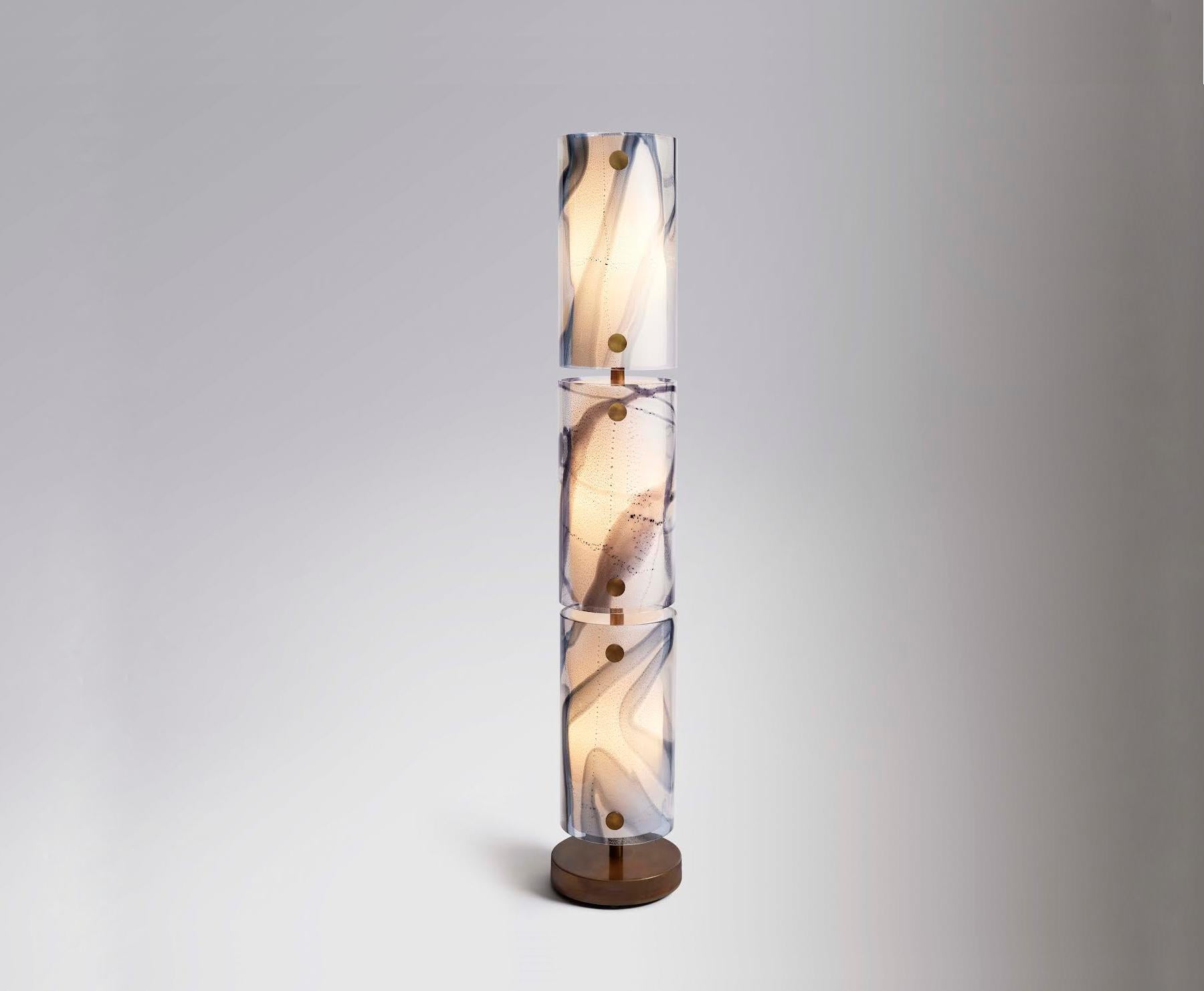 Fabricated in Murano, Italy by storied glassblower Seguso, Nur is a beacon of light, comprised of three cylinders of Venetian bigolo glass with silver leaf and a plexiglass liner, hung on a bronze base.

Electrical: Six G9 bulbs, incandescent 60 w