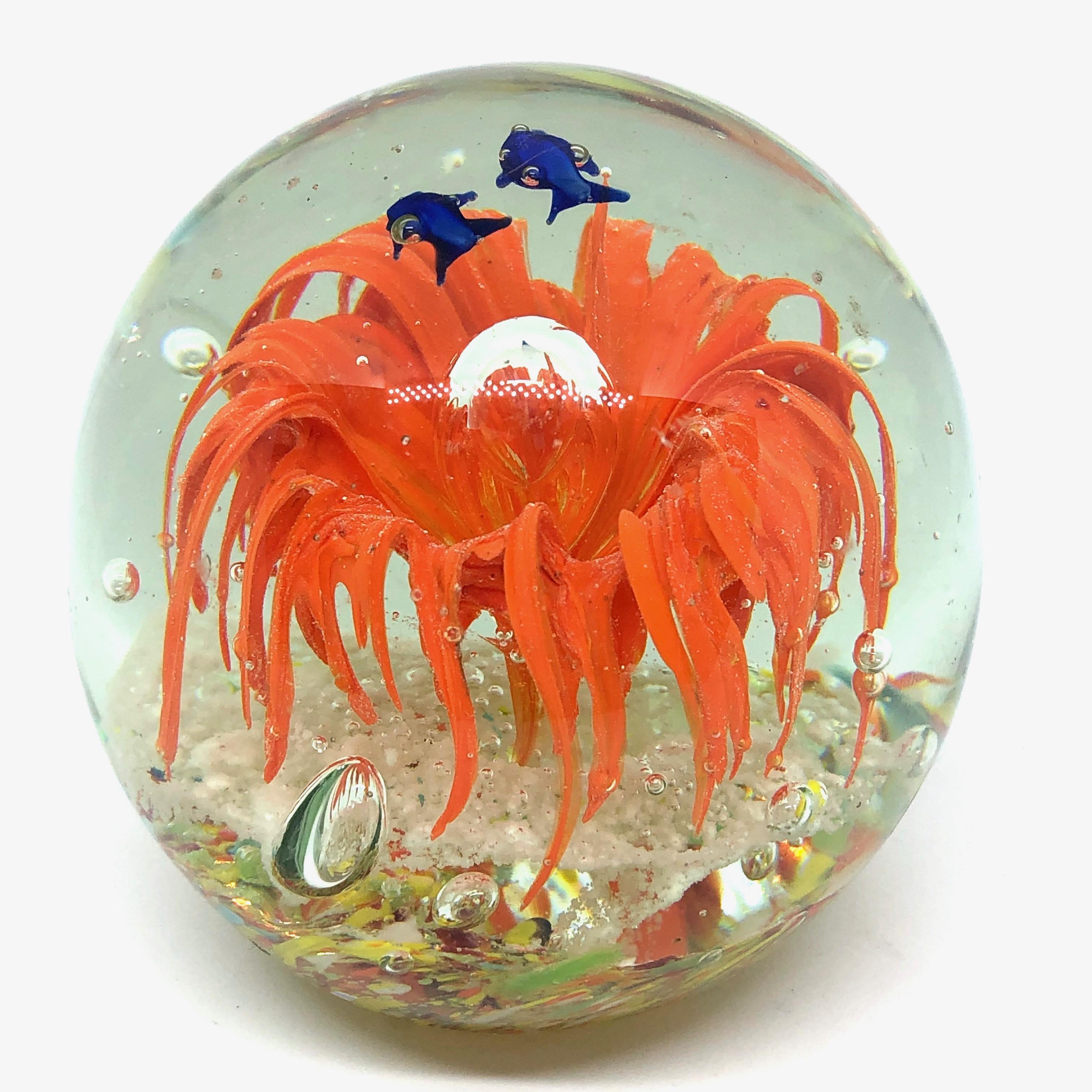 Beautiful Murano hand blown aquarium Italian art glass paper weight. Showing some blue fishes in a coral reef, floating on controlled bubbles. Colors are a blue, orange and clear. A beautiful nice addition to your desktop or as a decorative piece in
