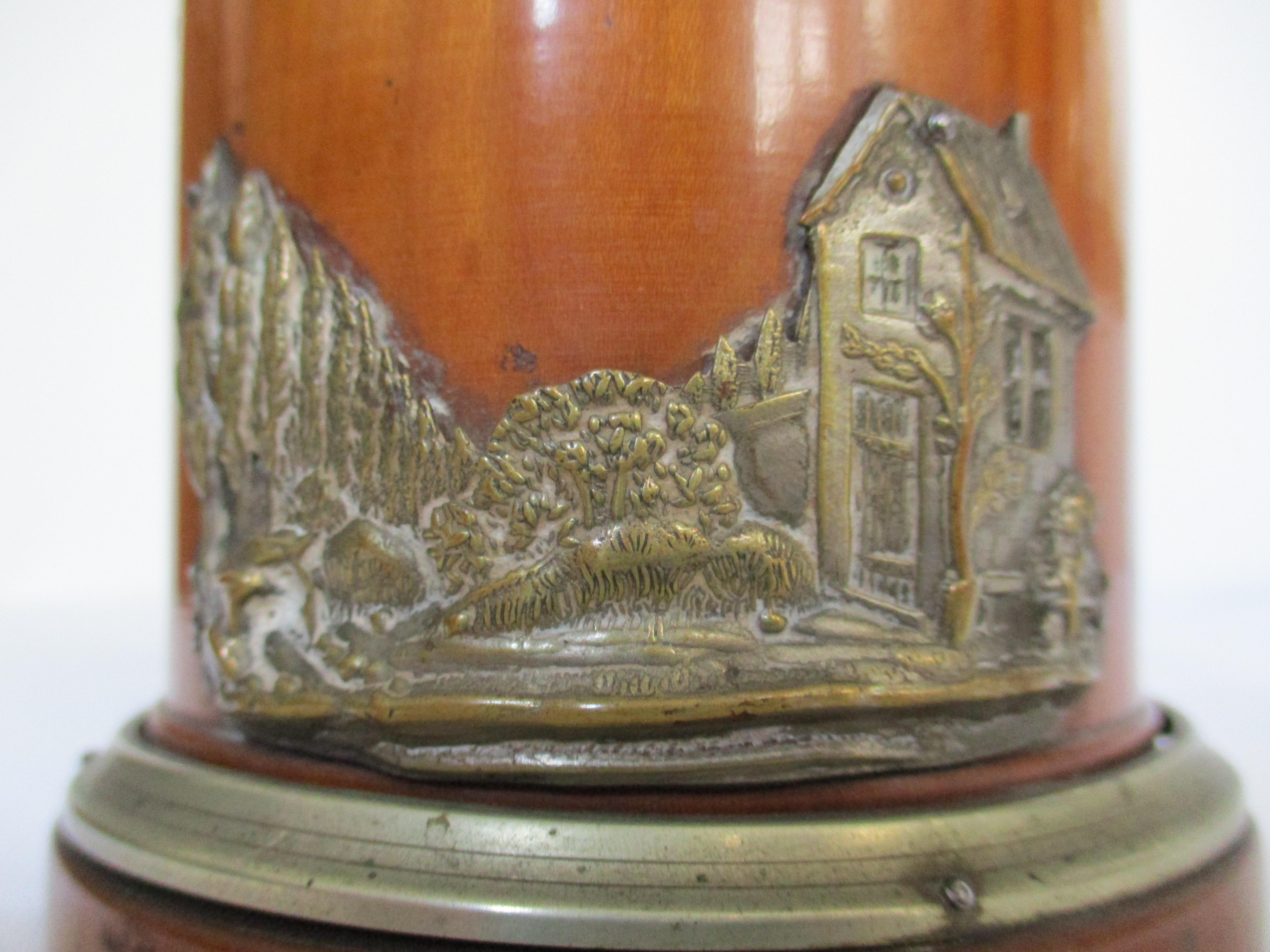 A wonderful tea vessel made out of cherry wood in Vienna in about 1830-1850. Beautifully decorated by a silver plated application of a house and a landscape (some brassing).