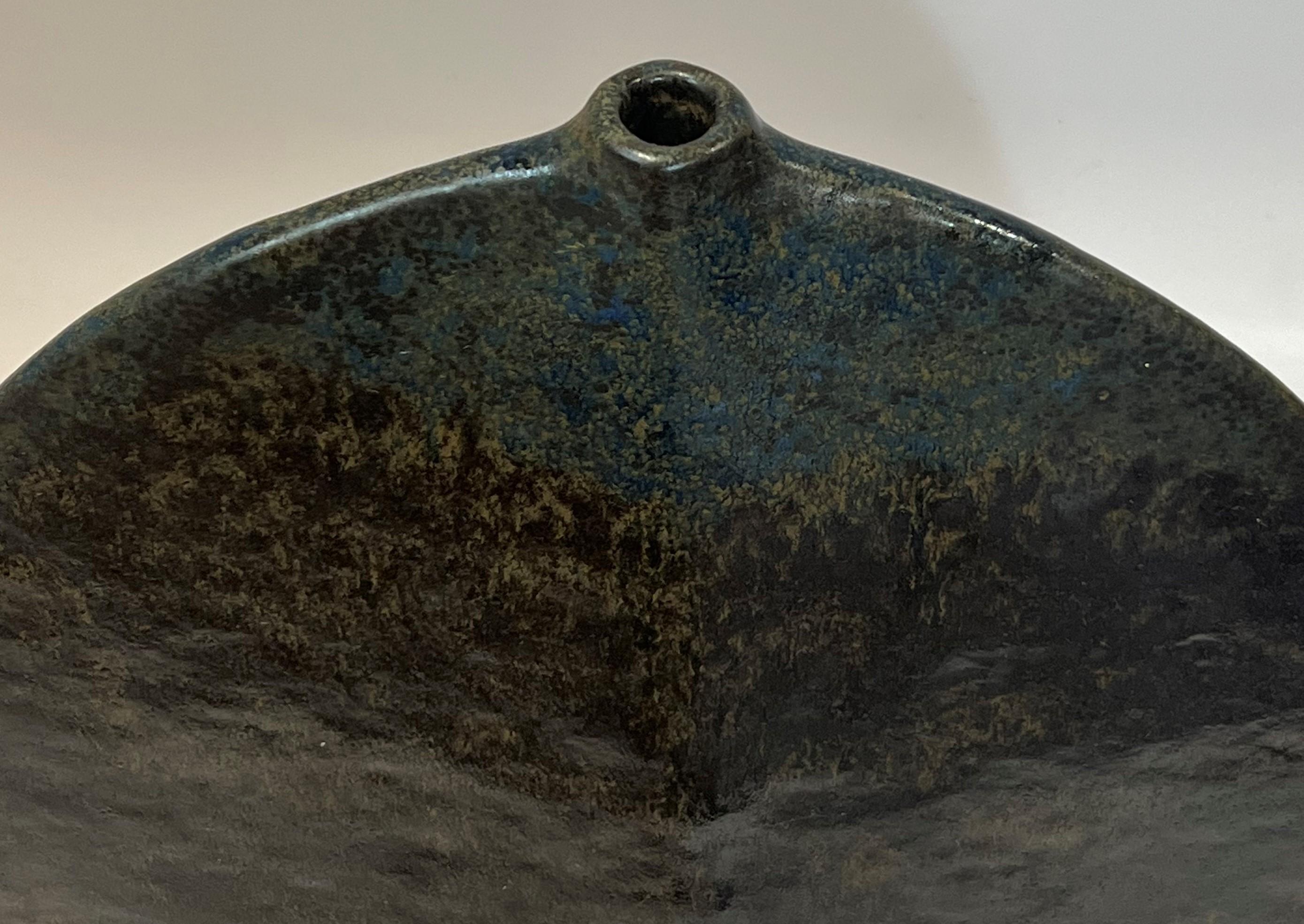 Gerald Weigel is a German ceramicist and founding member of group 83. His work with sophisticated glazes on simple nature inspired forms is collected across the globe. This large example features a rich overlay of glaze that appears to be alkaline