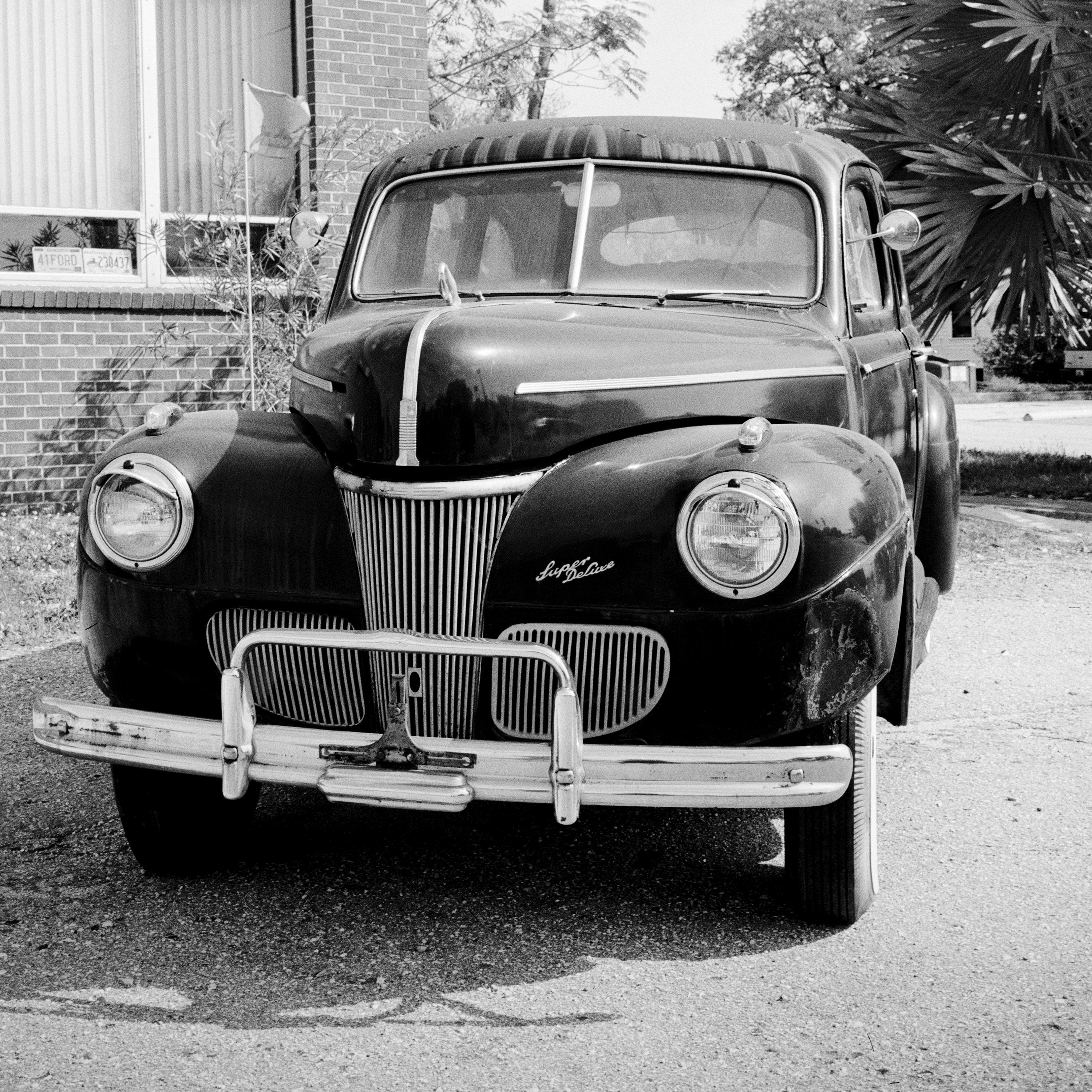 Black and White Fine Art Photography for Sale - 1941 Ford Super Deluxe Business Coupe, classic car, old timer in front of a house with palm trees. Archival pigment ink print, edition of 9. Signed, titled, dated and numbered by artist. Certificate of