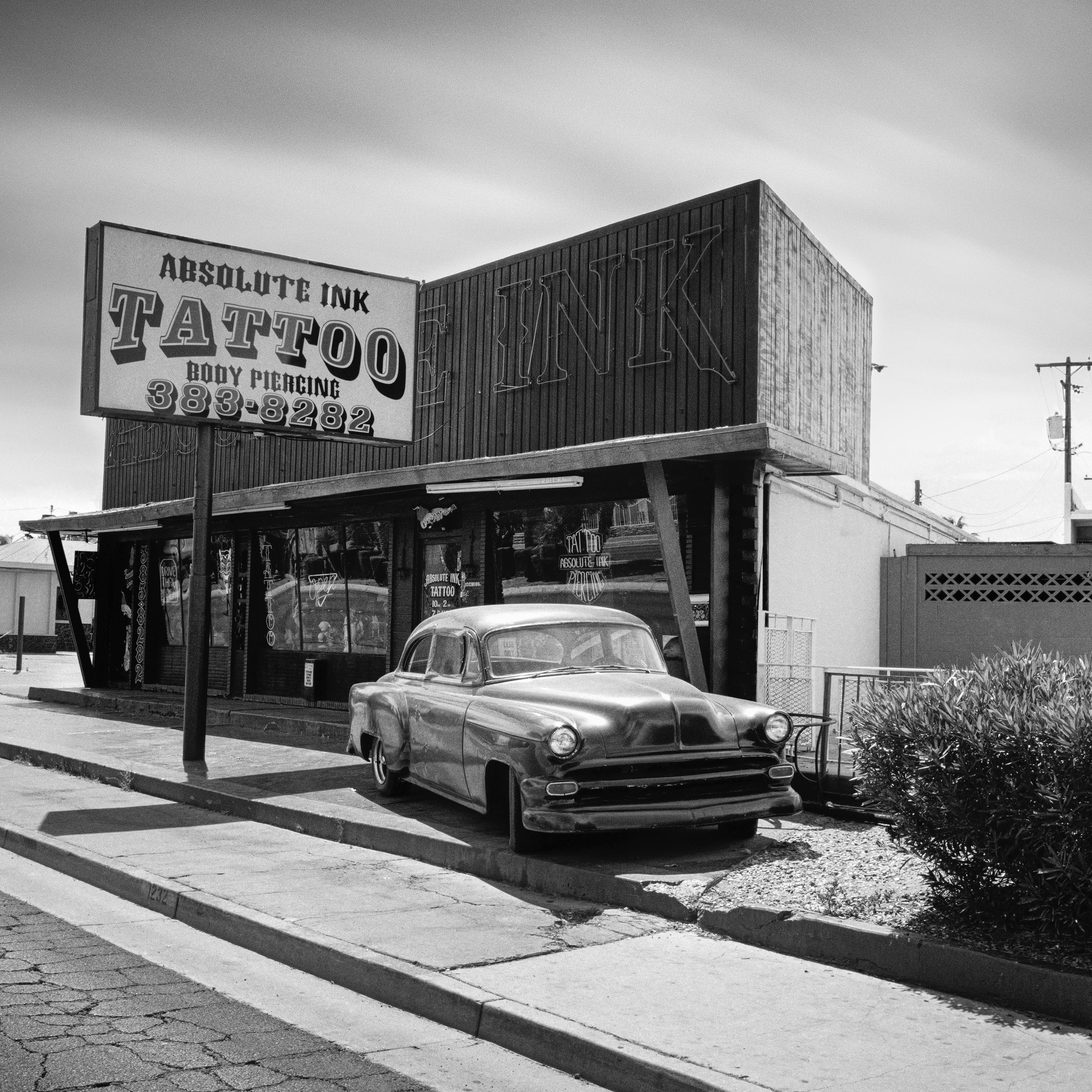 Black and white fine art landscape photography. Absolute Ink Tattoo with classic us car in las Vegas, Nevada, USA. Archival pigment ink print as part of a limited edition of 9. All Gerald Berghammer prints are made to order in limited editions on