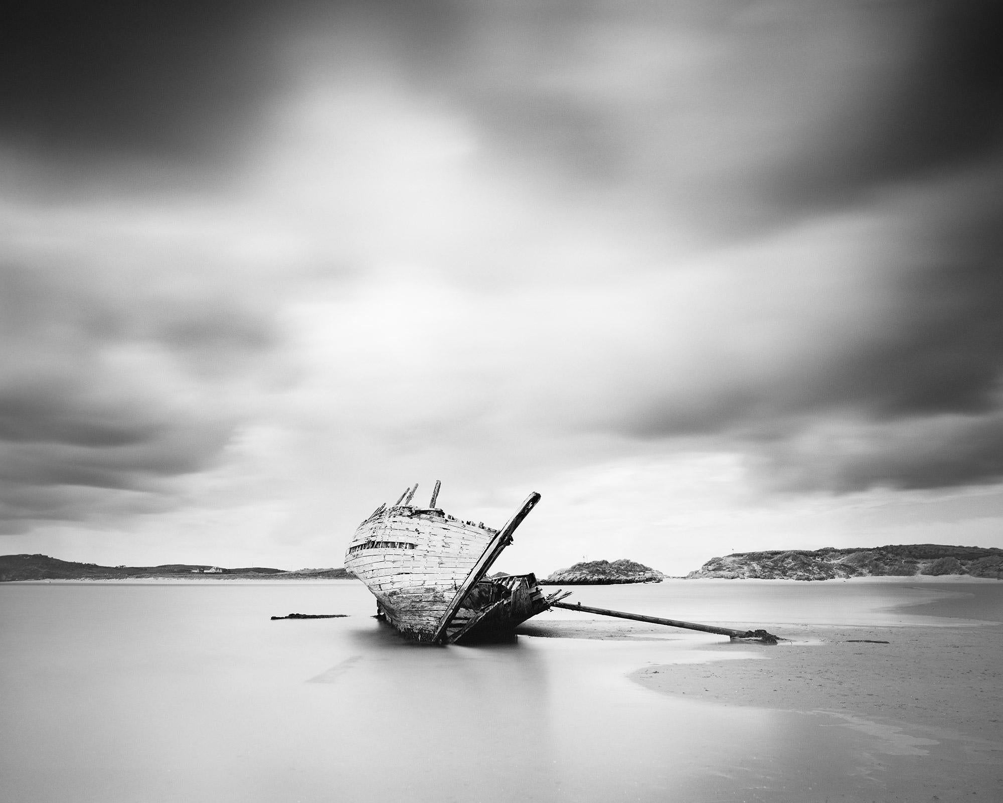 Gerald Berghammer Landscape Photograph - Bad Eddies, Sunken Boat, Beach, Ireland, black and white landscape photography