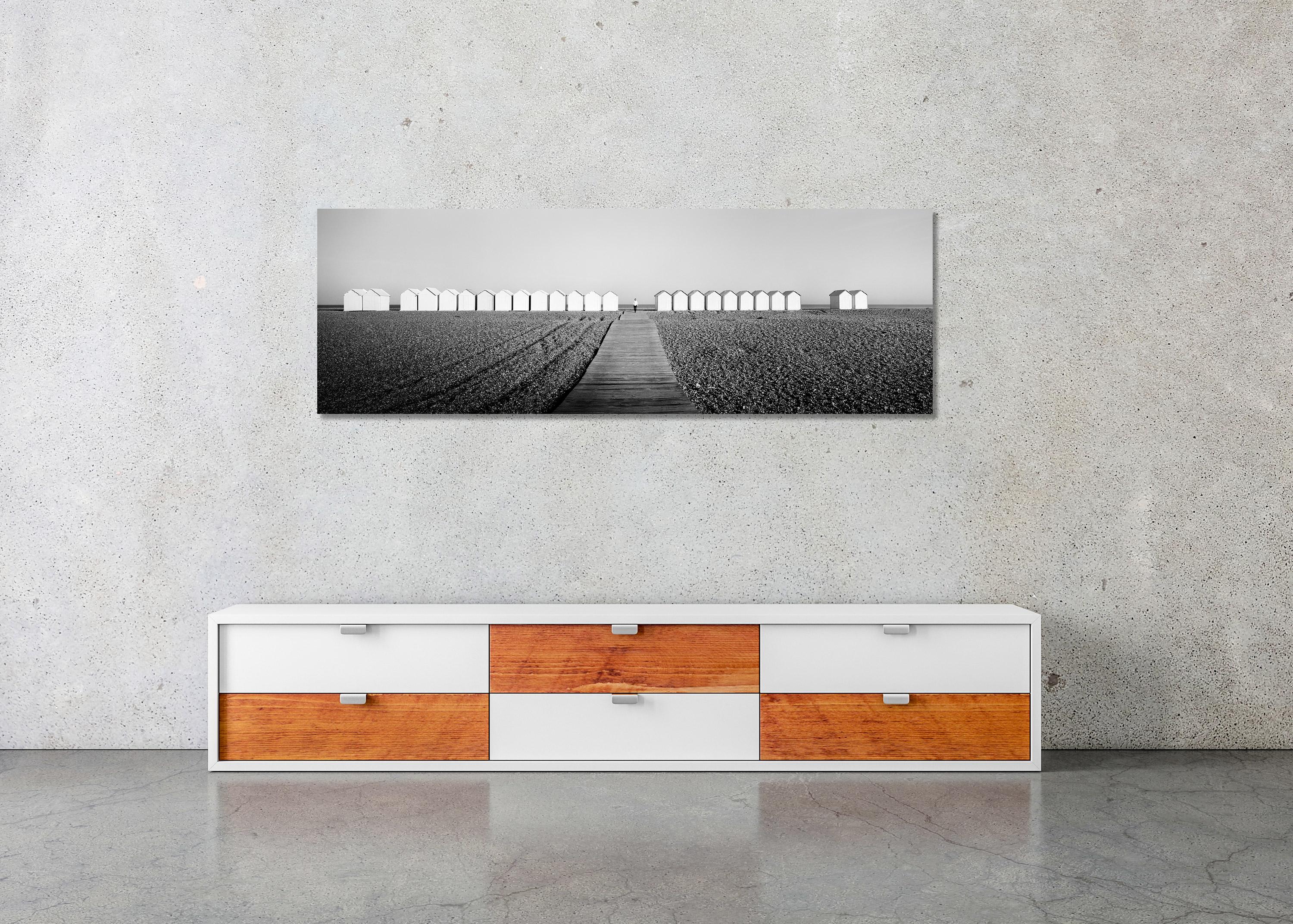 Black and white fine art panorama - landscape photography. Beach Huts, Panorama, Pier, Runner, France. Archival pigment ink print, edition of 9. Signed, titled, dated and numbered by artist. Certificate of authenticity included. Printed with 4cm
