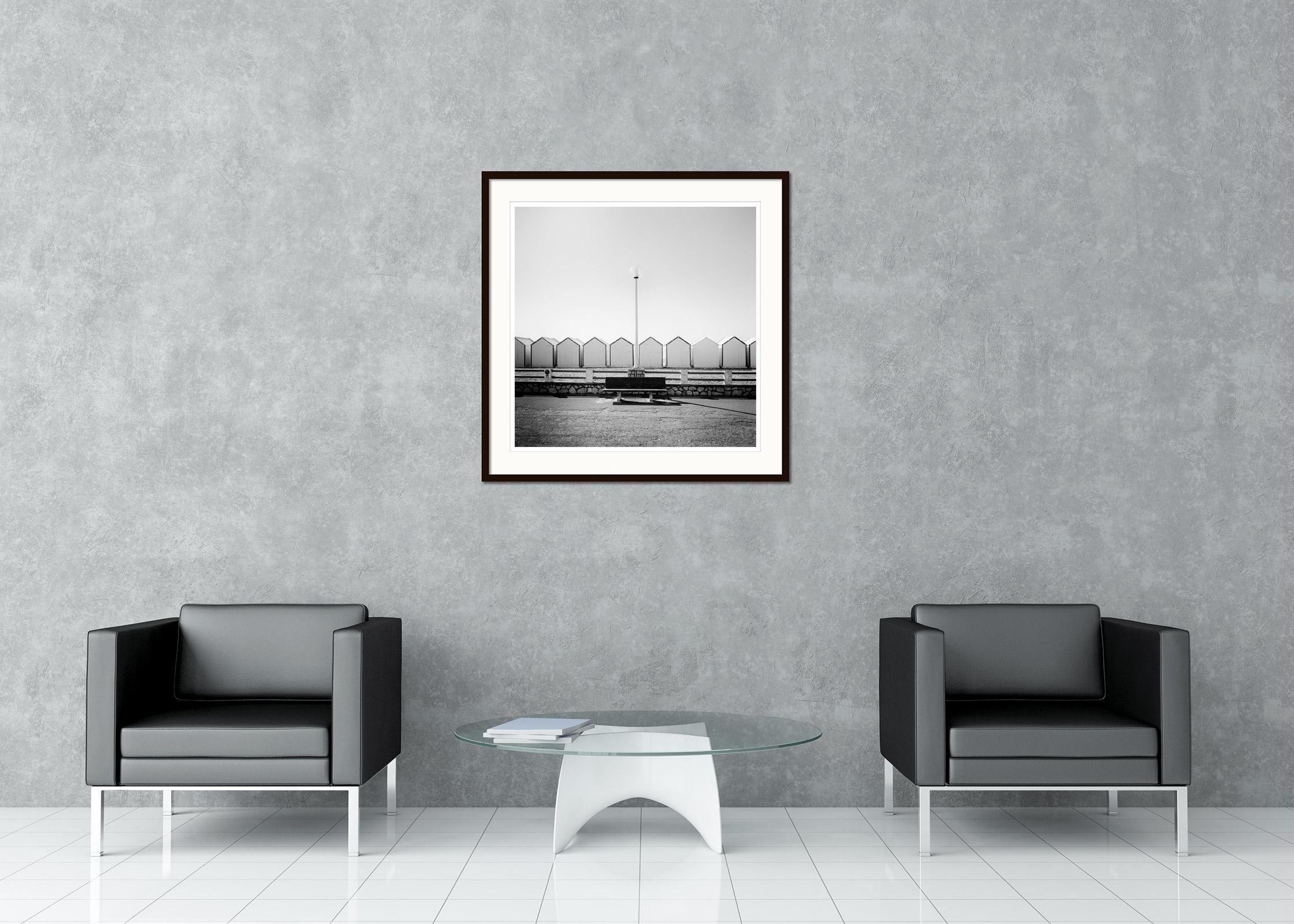 Bench on the Promenade beach huts France black white landscape art photography - Gray Black and White Photograph by Gerald Berghammer