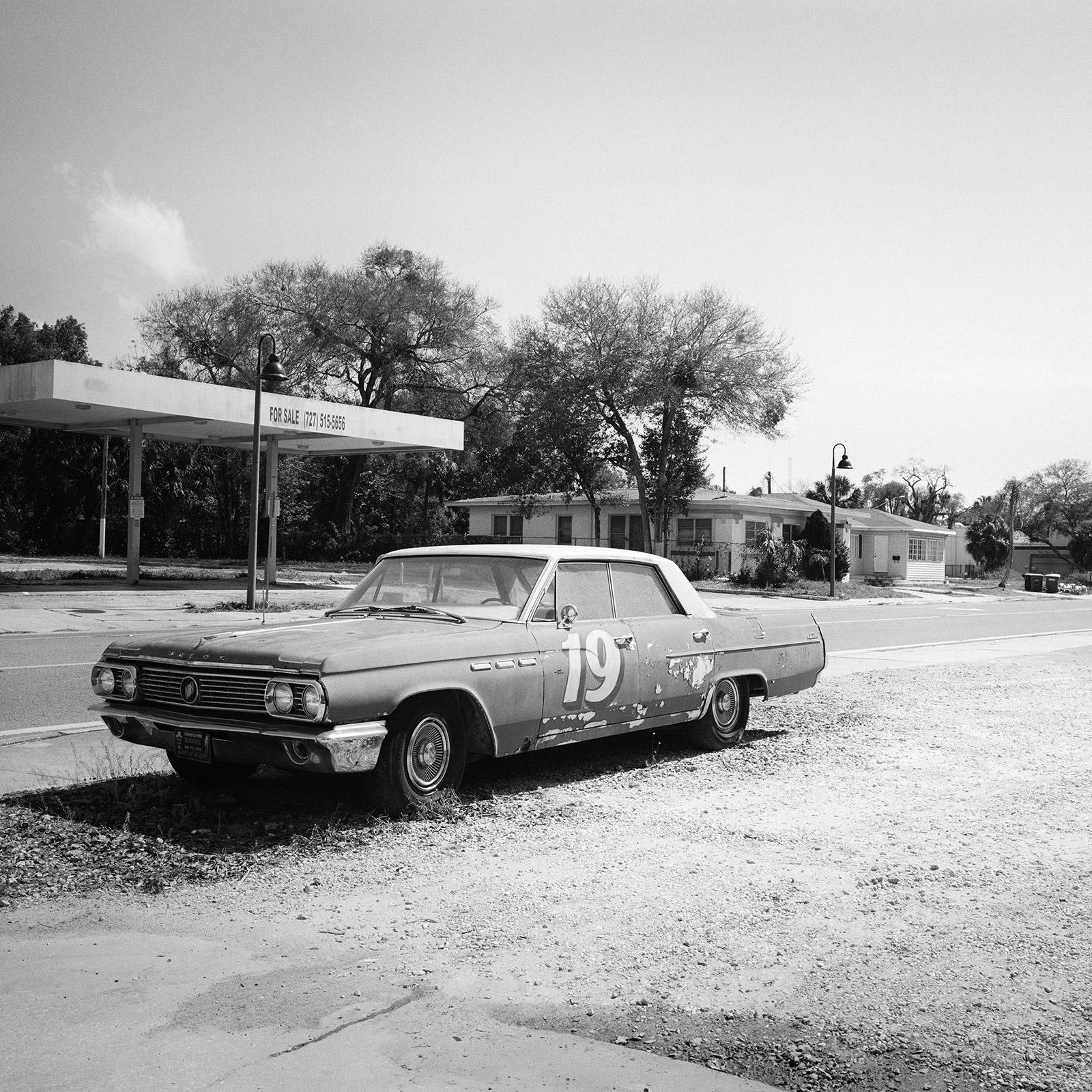 Gerald Berghammer Landscape Photograph - Buick for sale, classic car, Florida, USA, black and white landscape photography