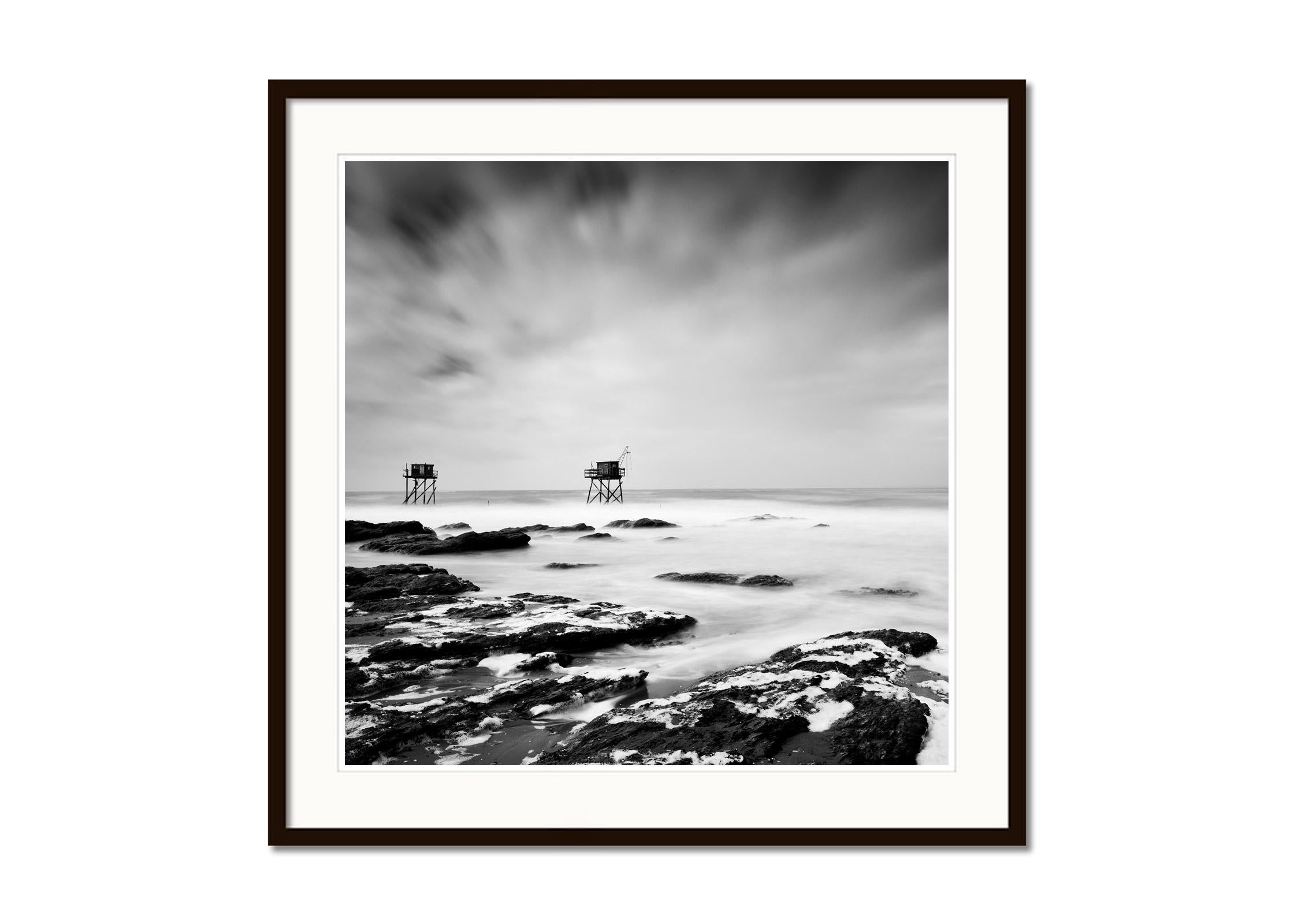Fishing Hut on Stilts, coast of Atlantic Ocean, black and white waterscape - Gray Black and White Photograph by Gerald Berghammer