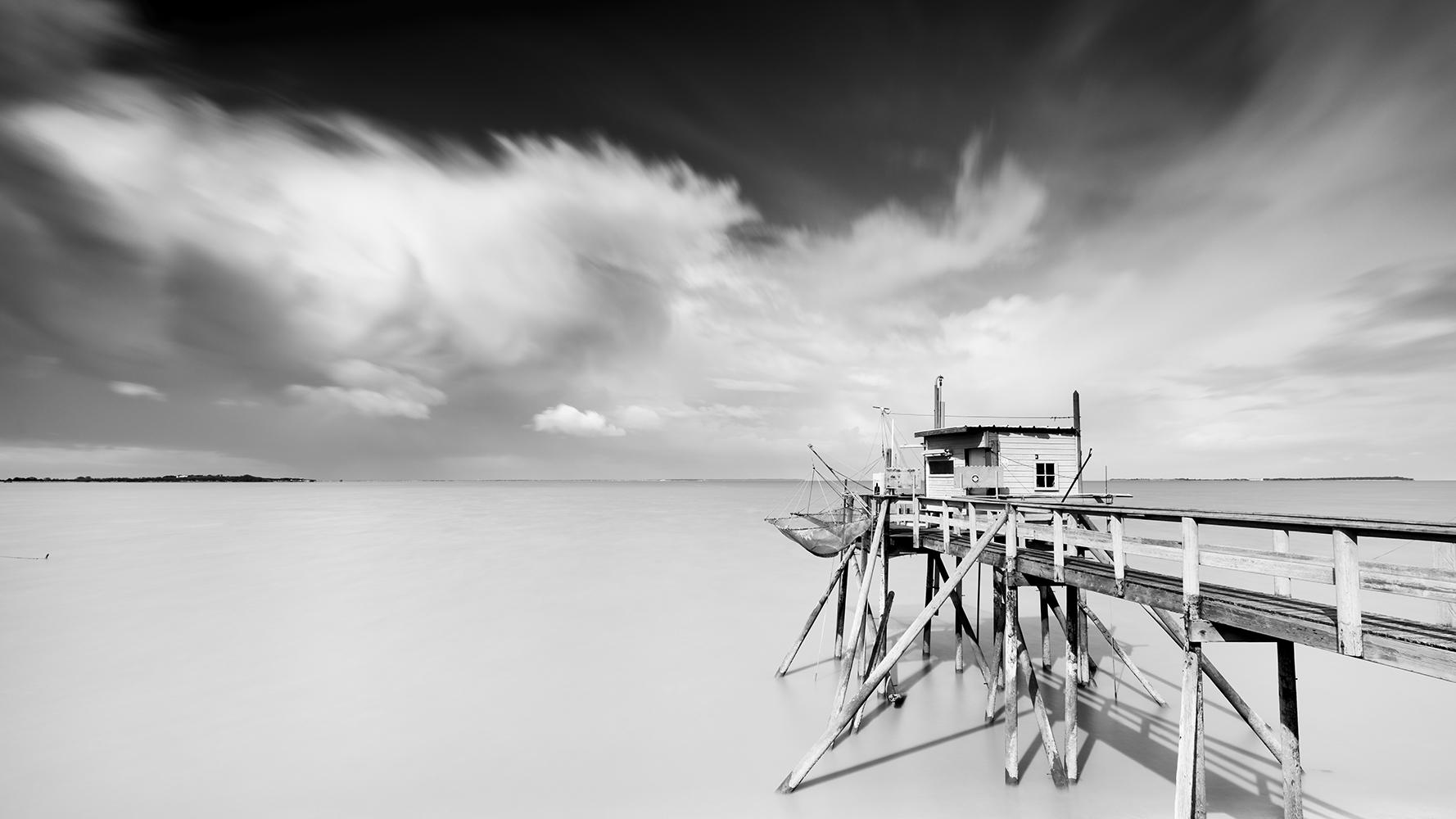 Gerald Berghammer Black and White Photograph - Fishing Hut on Stilts, Panorama, giant Clouds, fine art landscape photography