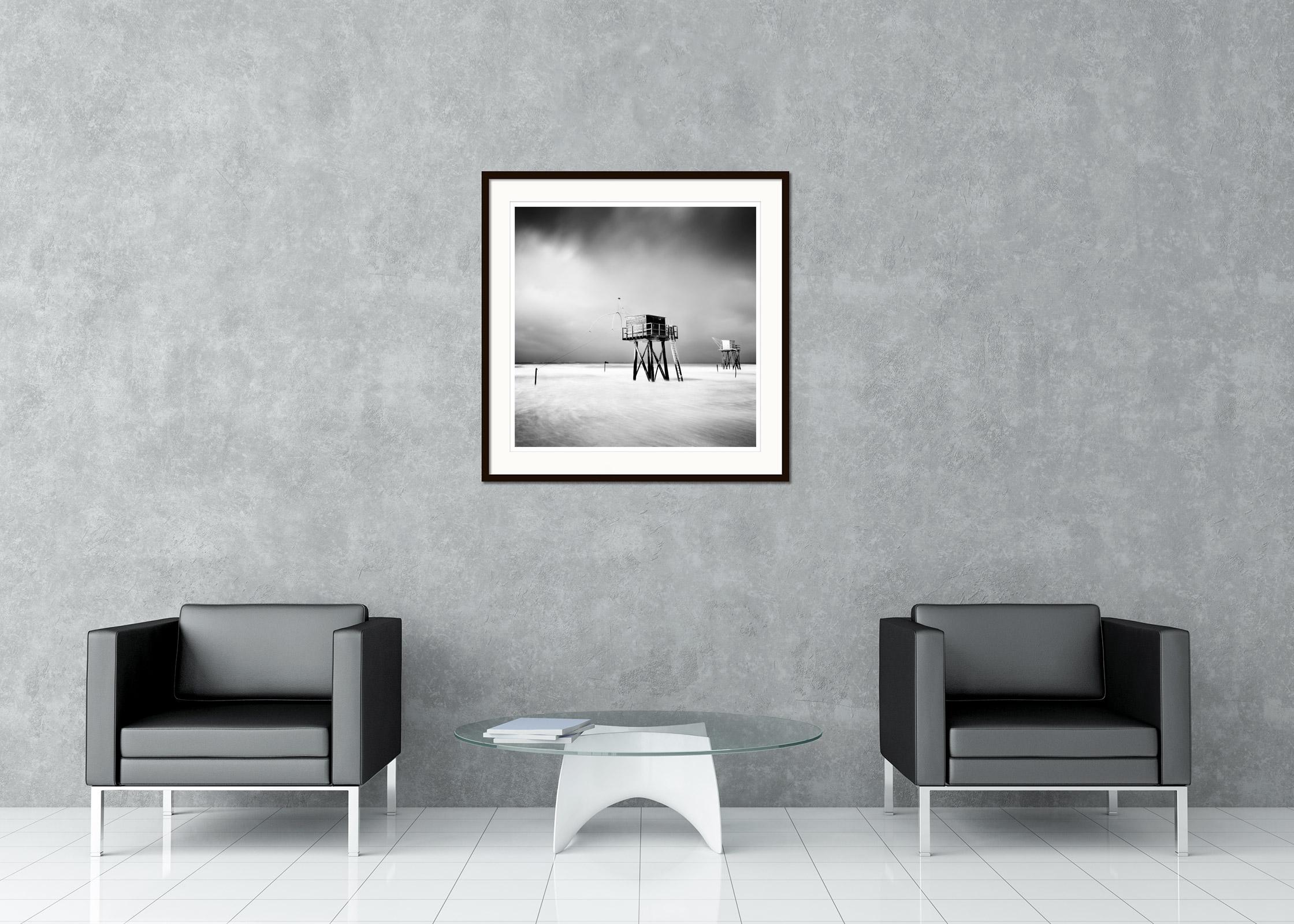 Black and white fine art long exposure waterscape - landscape photography. Fishing Hut On Stilts in the surf on the beach at Saint Michel chef chef in France. Archival pigment ink print as part of a limited edition of 8. All Gerald Berghammer prints