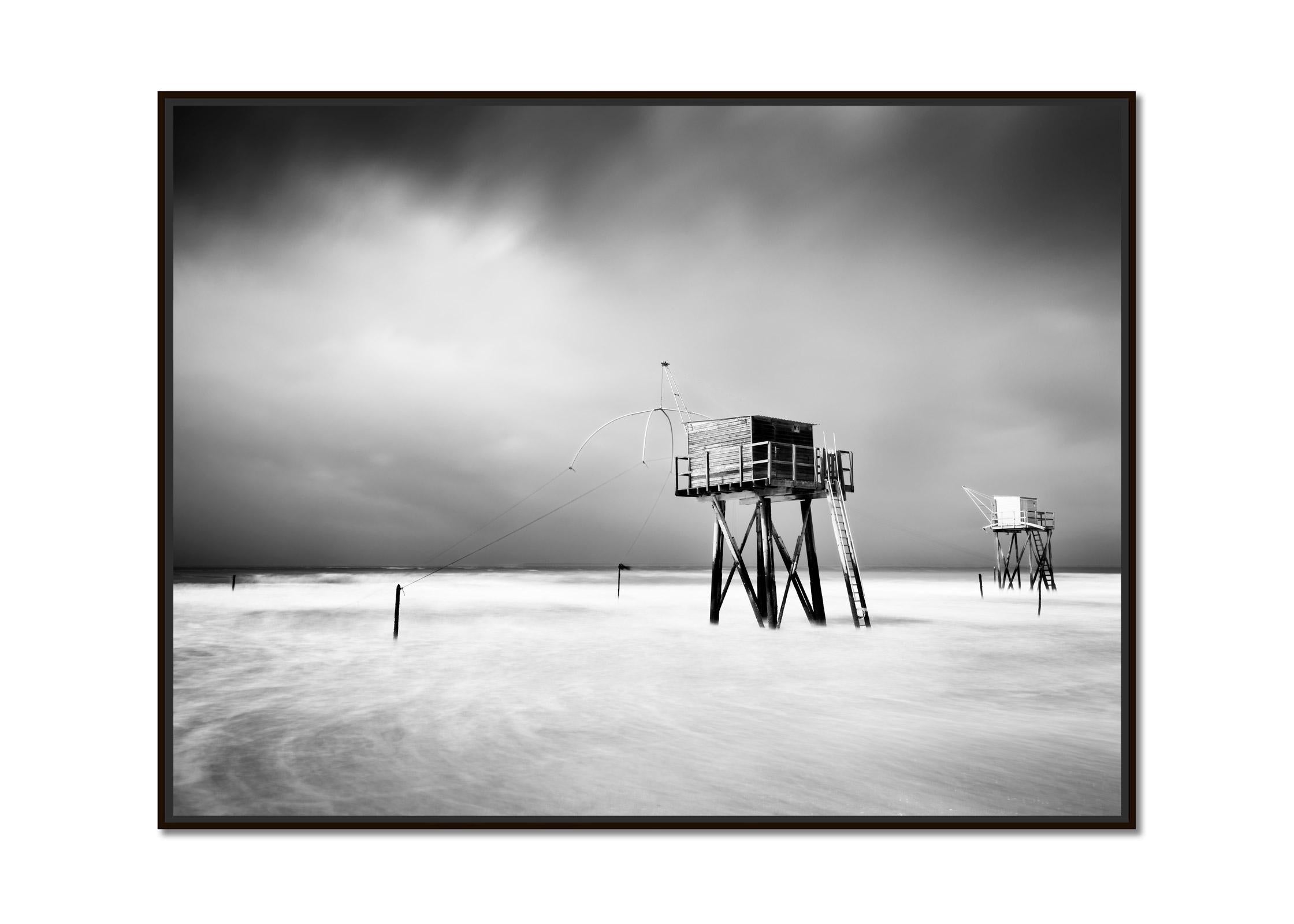 Fishing Hut On Stilts, surf, shoreline, storm, black white landscape photography - Photograph by Gerald Berghammer