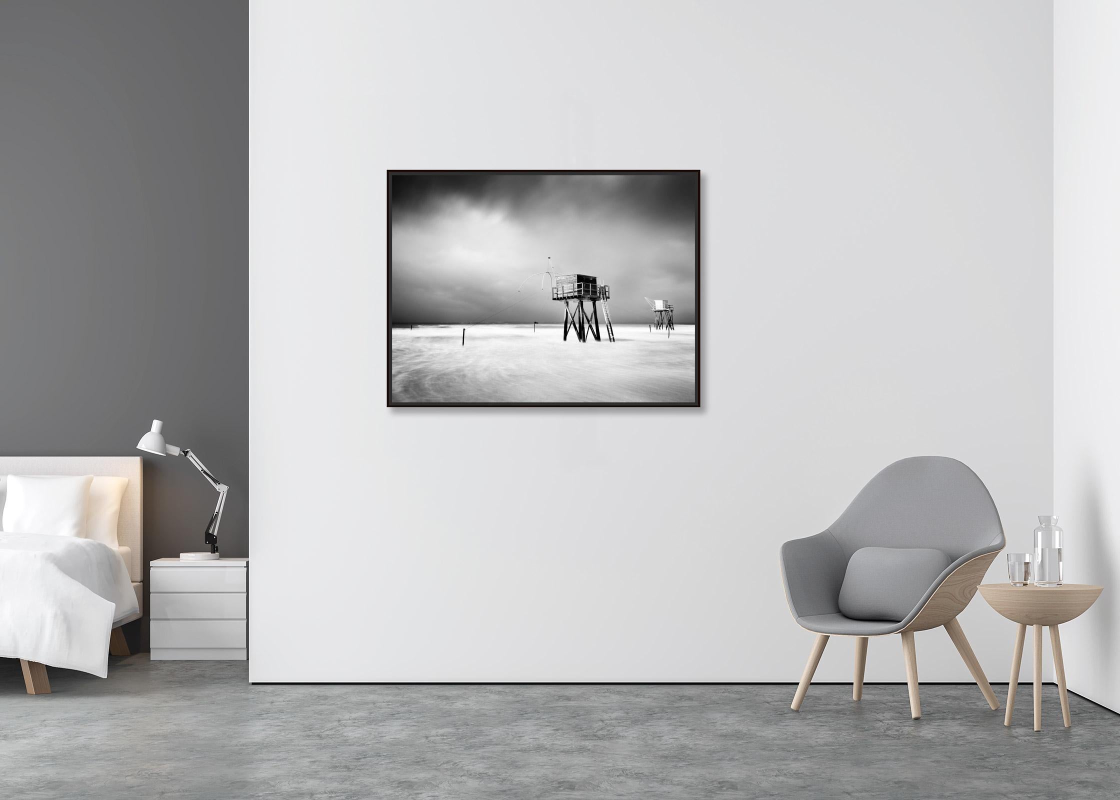 Fishing Hut on Stilts, shoreline, storm, black white photography, landscape, art - Contemporary Photograph by Gerald Berghammer