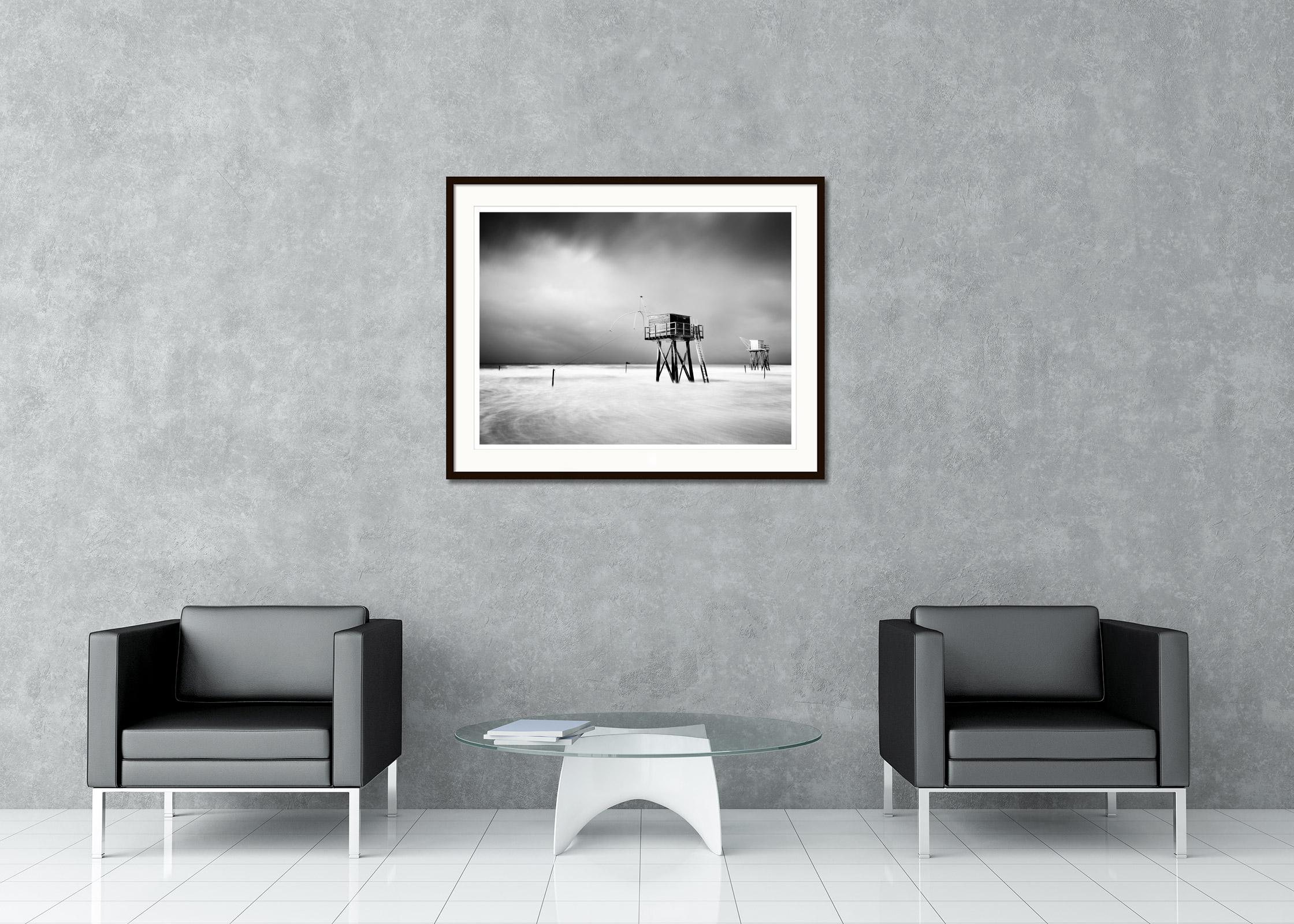 Black and white fine art long exposure waterscape - landscape photography print. Fishermen's huts on stilts in the surf of the Atlantic coast of France. Archival pigment ink print, edition of 7. Signed, titled, dated and numbered by artist.