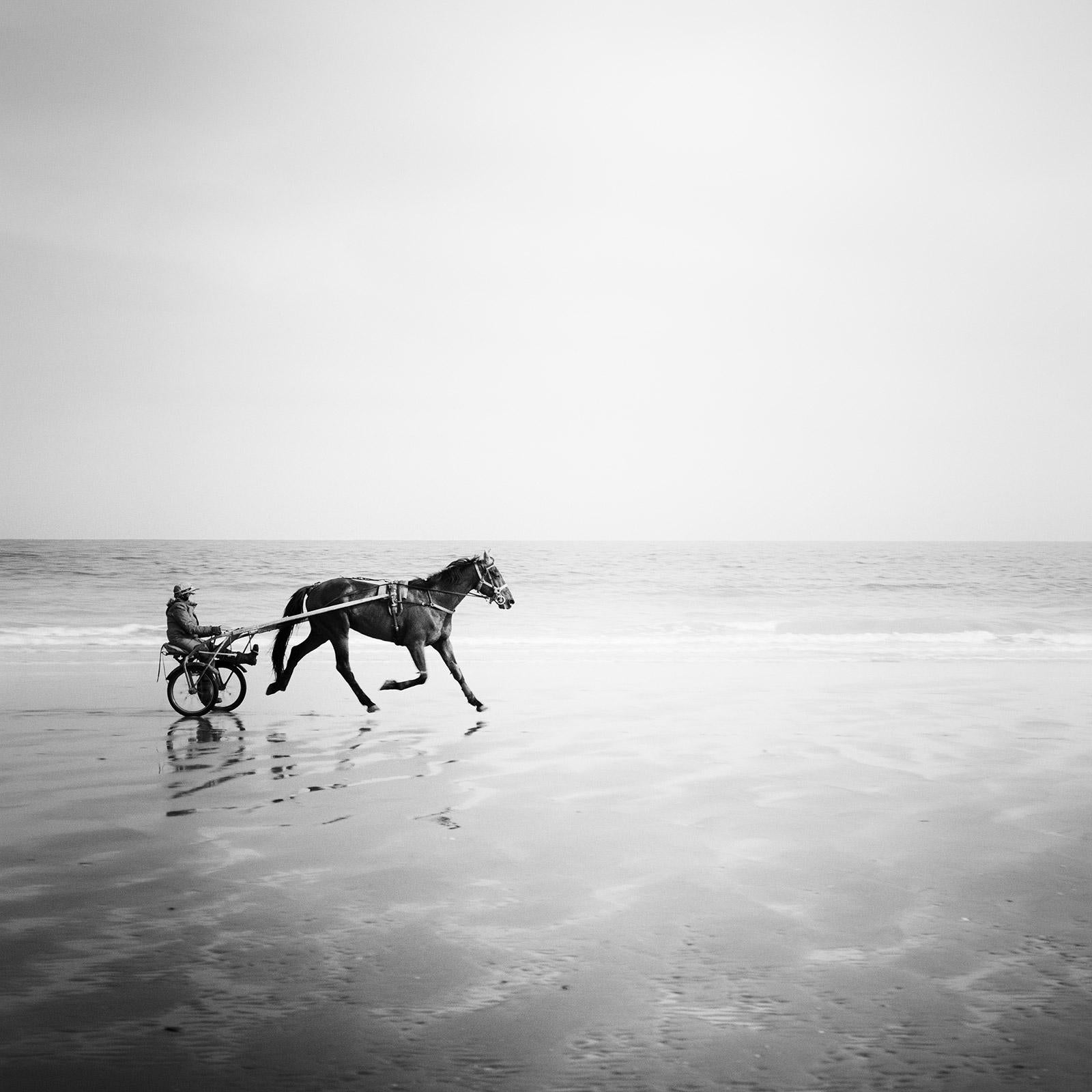 Gerald Berghammer Landscape Photograph - Harness Racing, France, Beach Normandie, France, black and white art photography