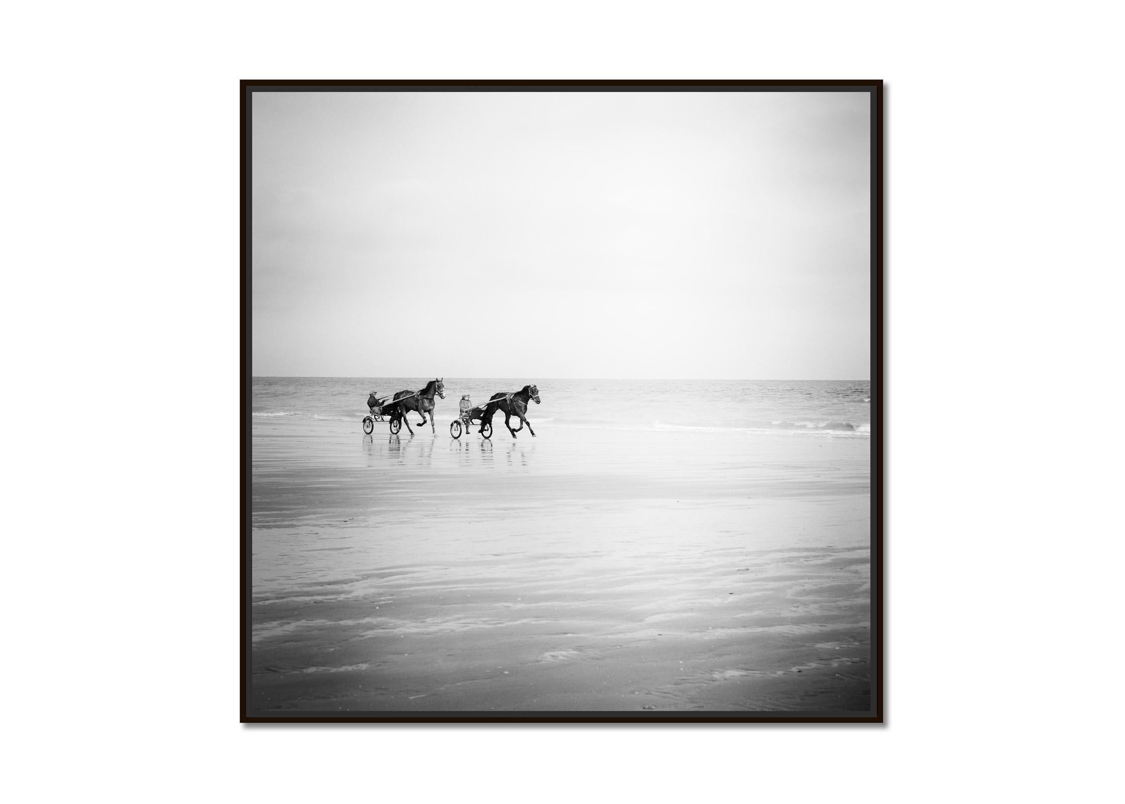 Harness Racing, horses on the beach, France, black white landscape photography - Photograph by Gerald Berghammer