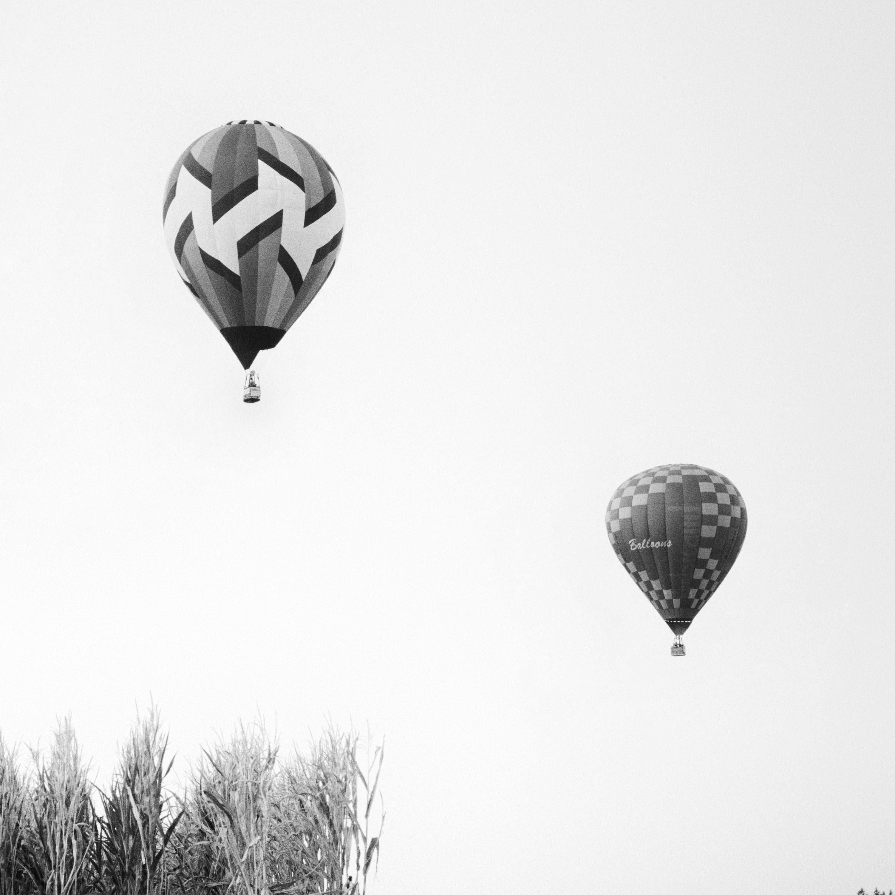Black and white fine art photography print. Two hot air balloons over a corn field during the world cup in Austria. Archival pigment ink print, edition of 9. Signed, titled, dated and numbered by artist. Certificate of authenticity included. Printed